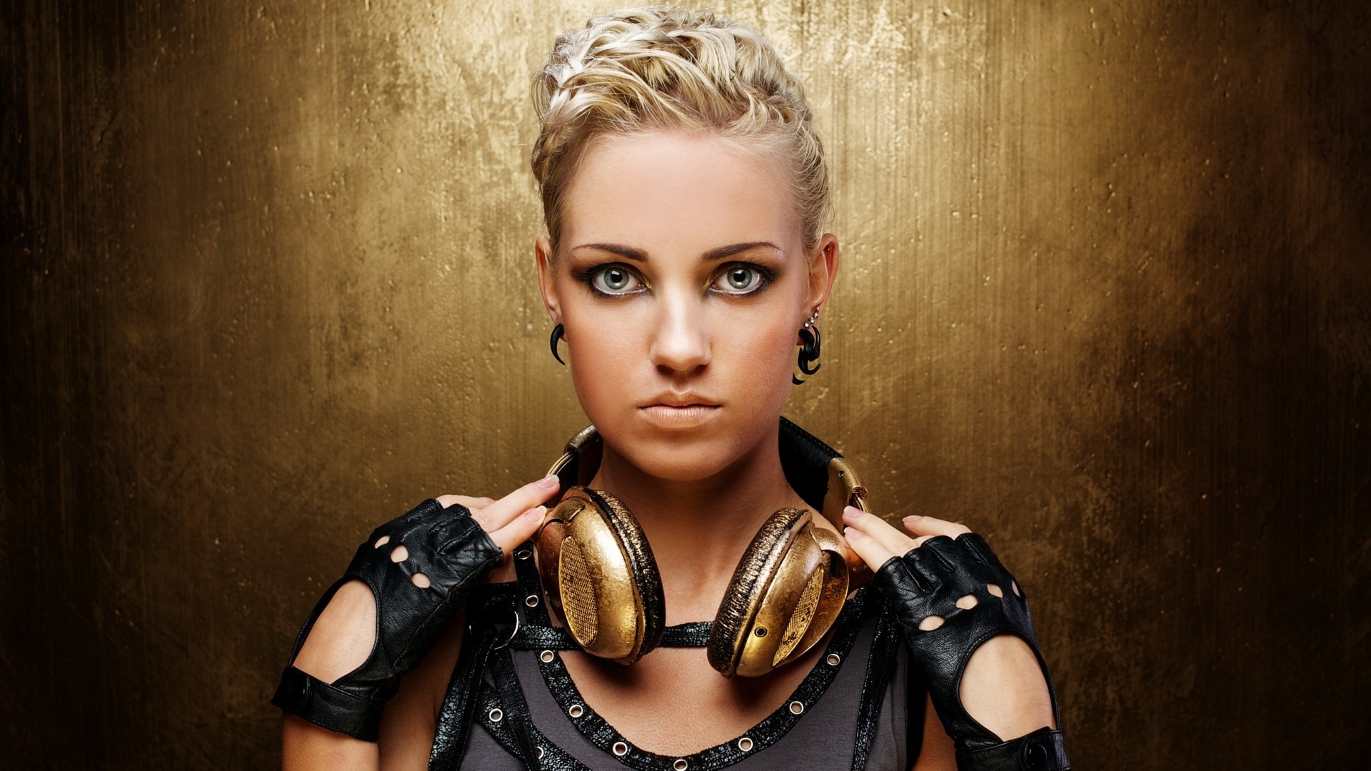 Woman with blonde hair wearing gold headphones and black mittens HD Wallpaper