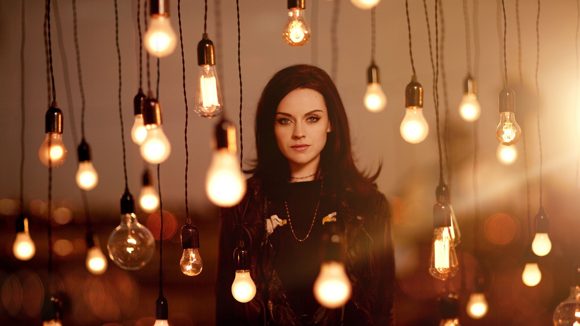 Amy Macdonald surrounded by hanging light bulbs HD Wallpaper