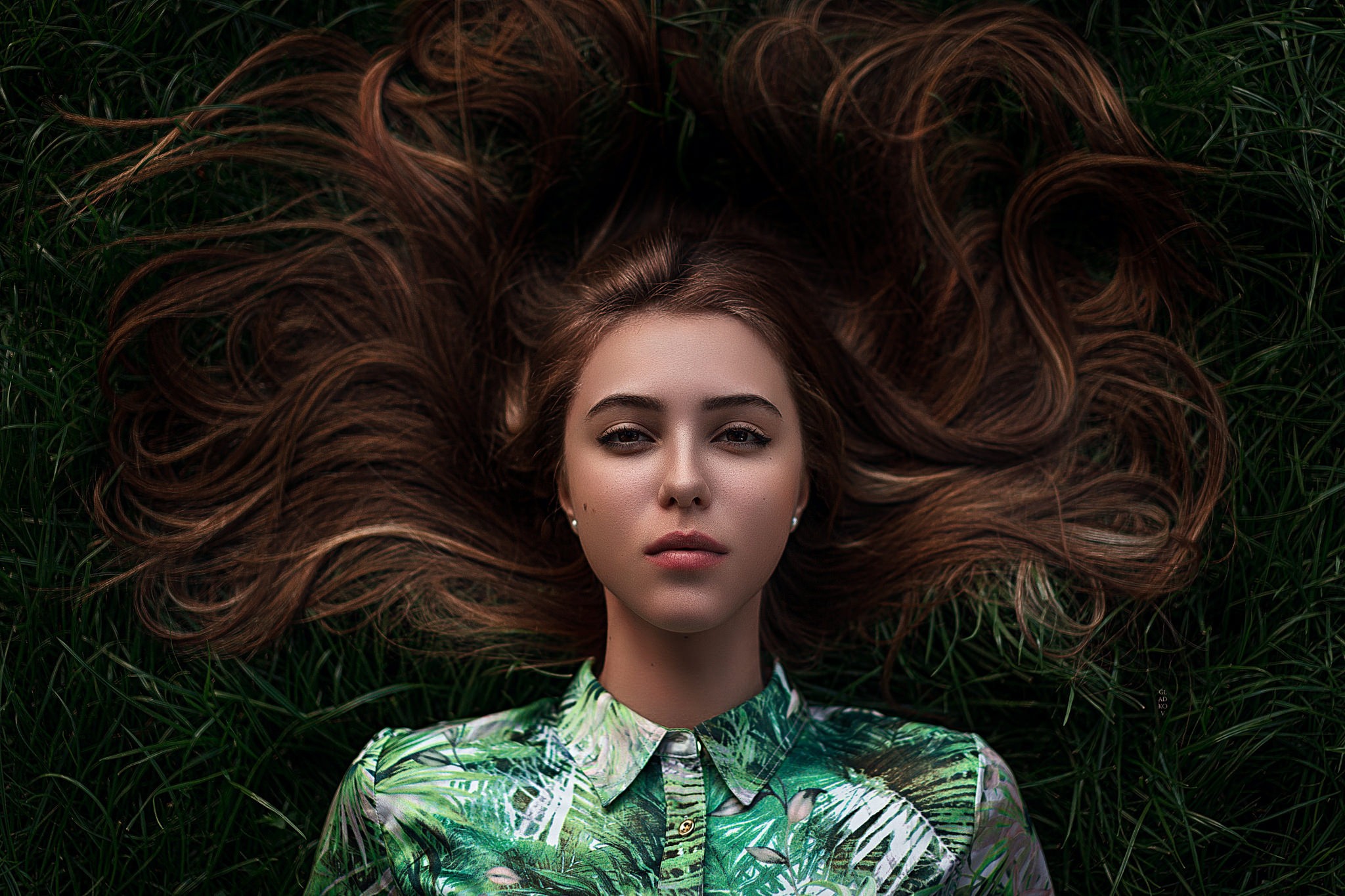 Woman lying on grass with long brown hair HD Wallpaper