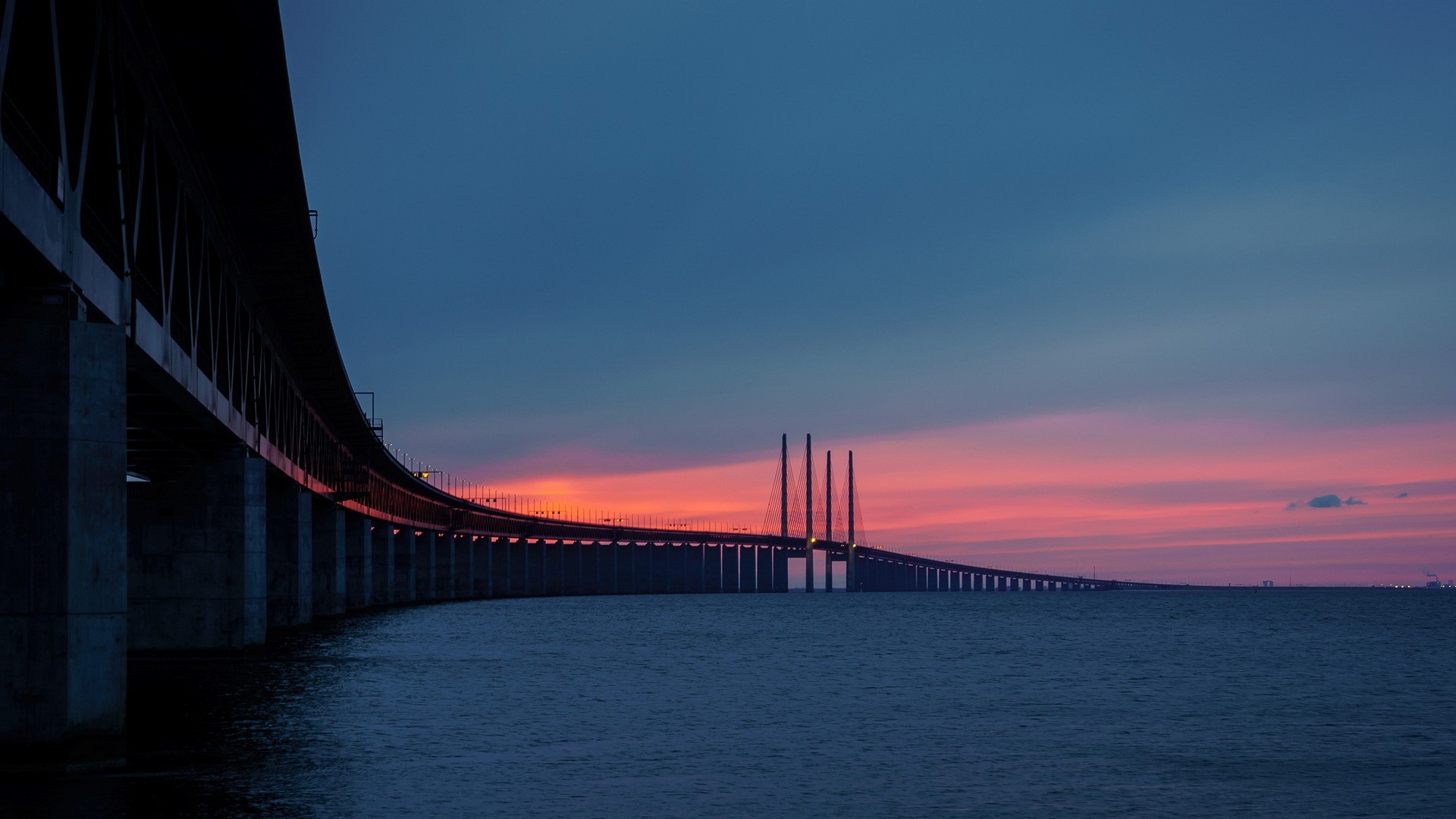 Öresund Bridge at sunset over the sea HD Wallpaper