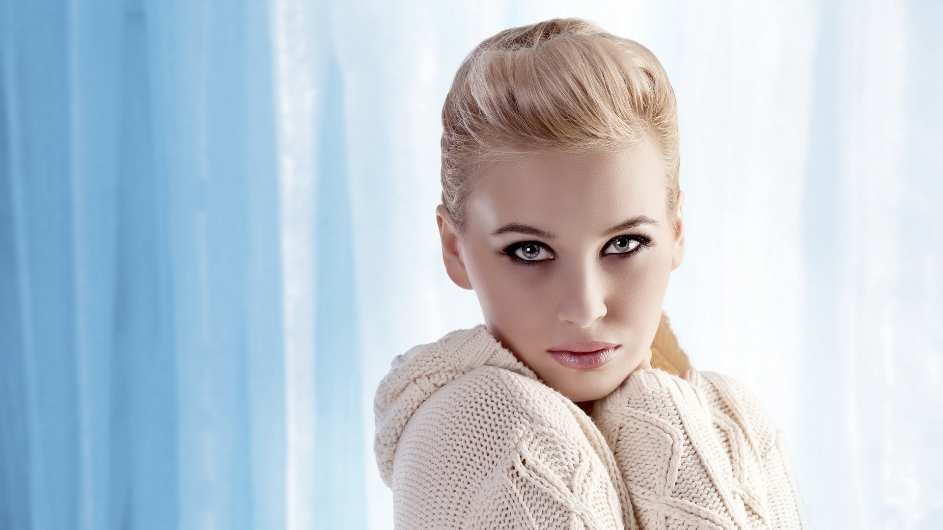 Woman with blonde hair and smoky eyes wearing a sweater HD Wallpaper