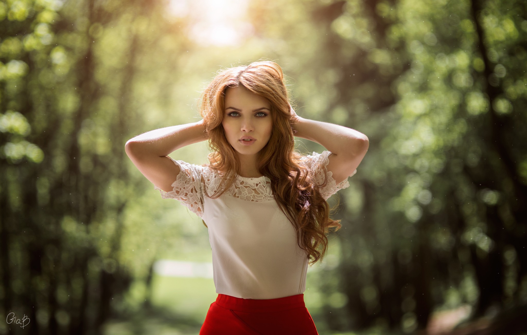Redhead woman with hands in hair in a forest HD Wallpaper