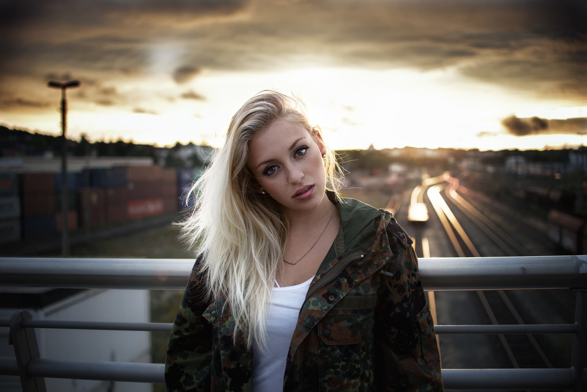 Woman with blonde hair wearing camouflage jacket HD Wallpaper