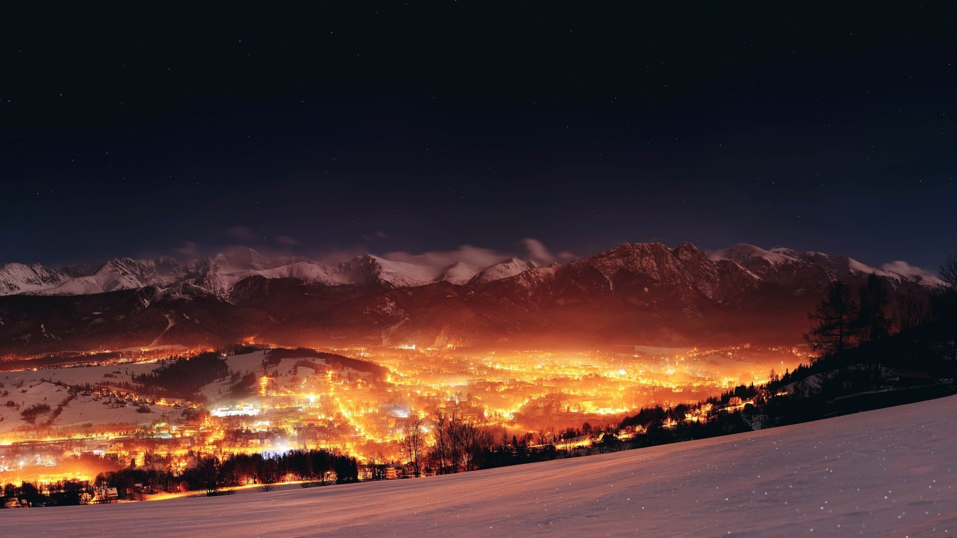 Zakopane cityscape at night with snowy mountains HD Wallpaper
