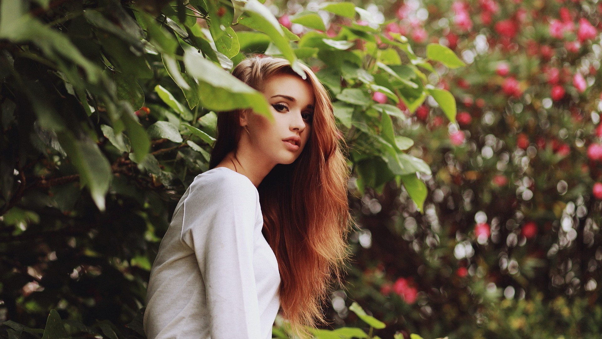Woman with long auburn hair in white clothing outdoors HD Wallpaper