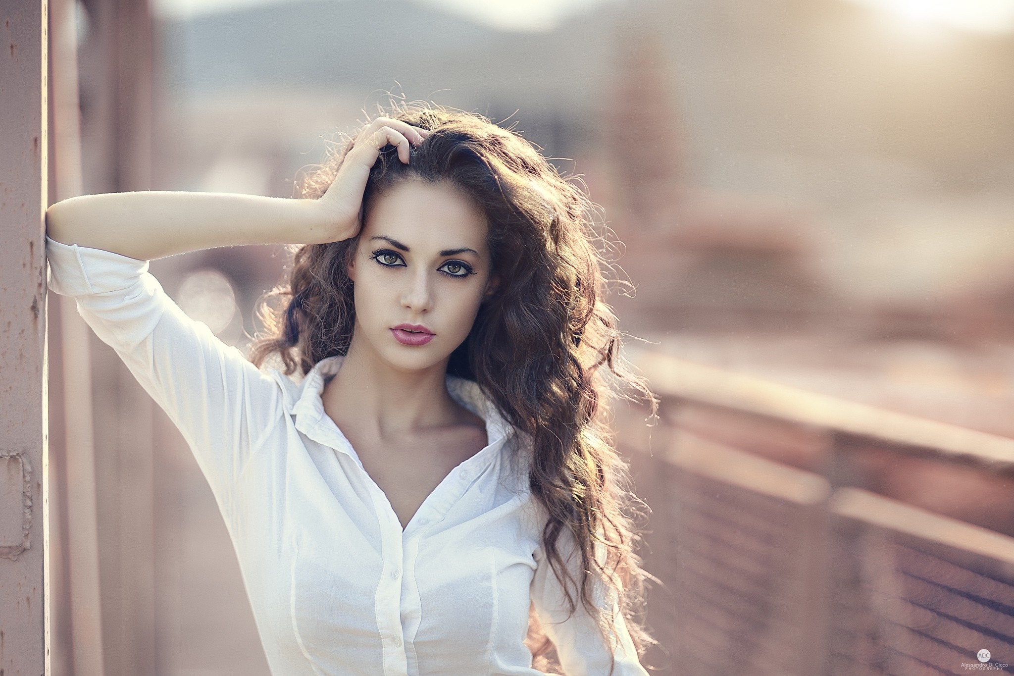 Woman with curly brown hair in a white shirt HD Wallpaper
