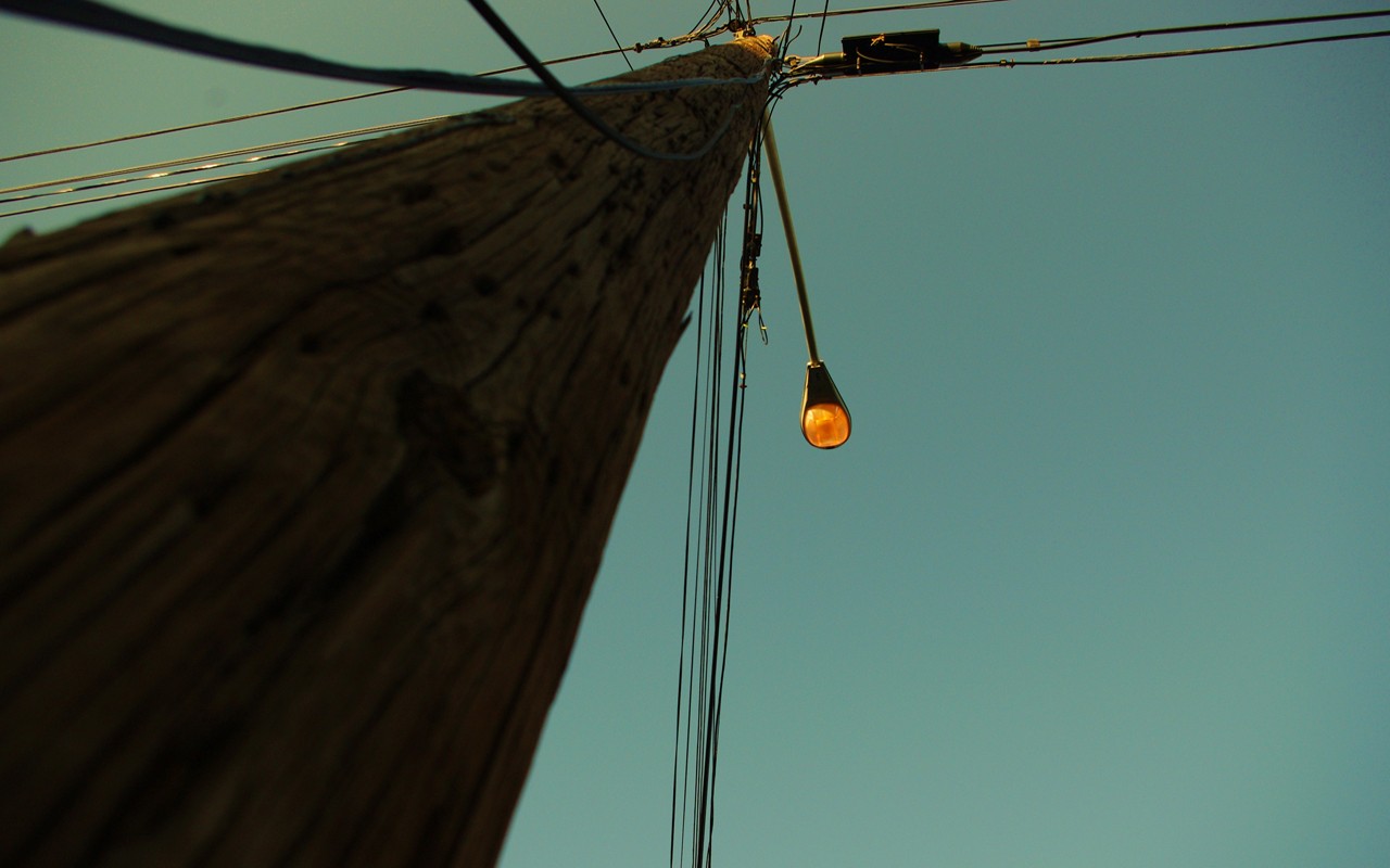 Worm's eye view of a utility pole with power lines and a street light HD Wallpaper