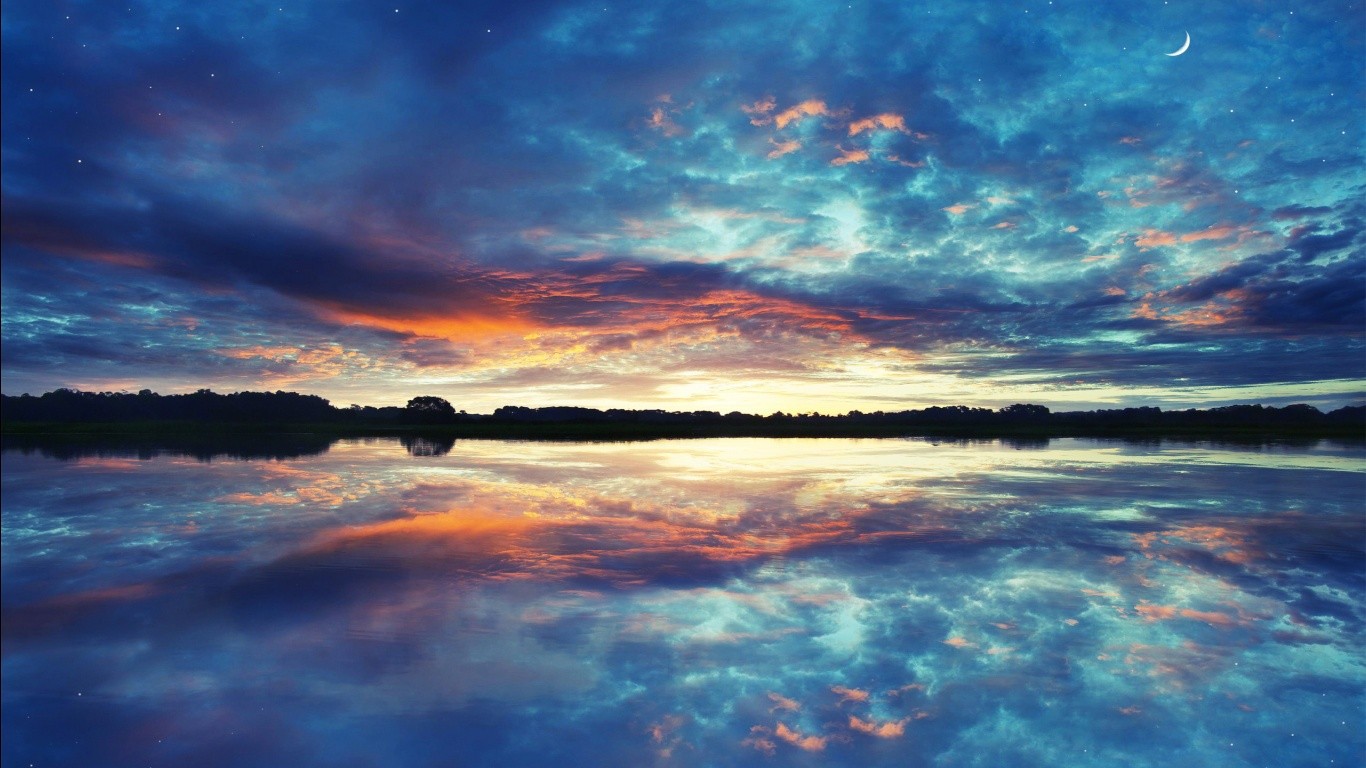 Sunset over a calm lake with reflections HD Wallpaper