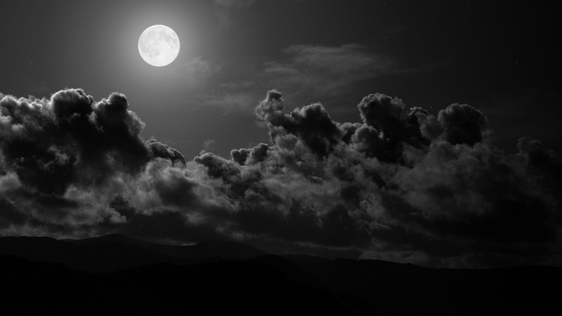 Full moon shining through dark clouds over mountains HD Wallpaper