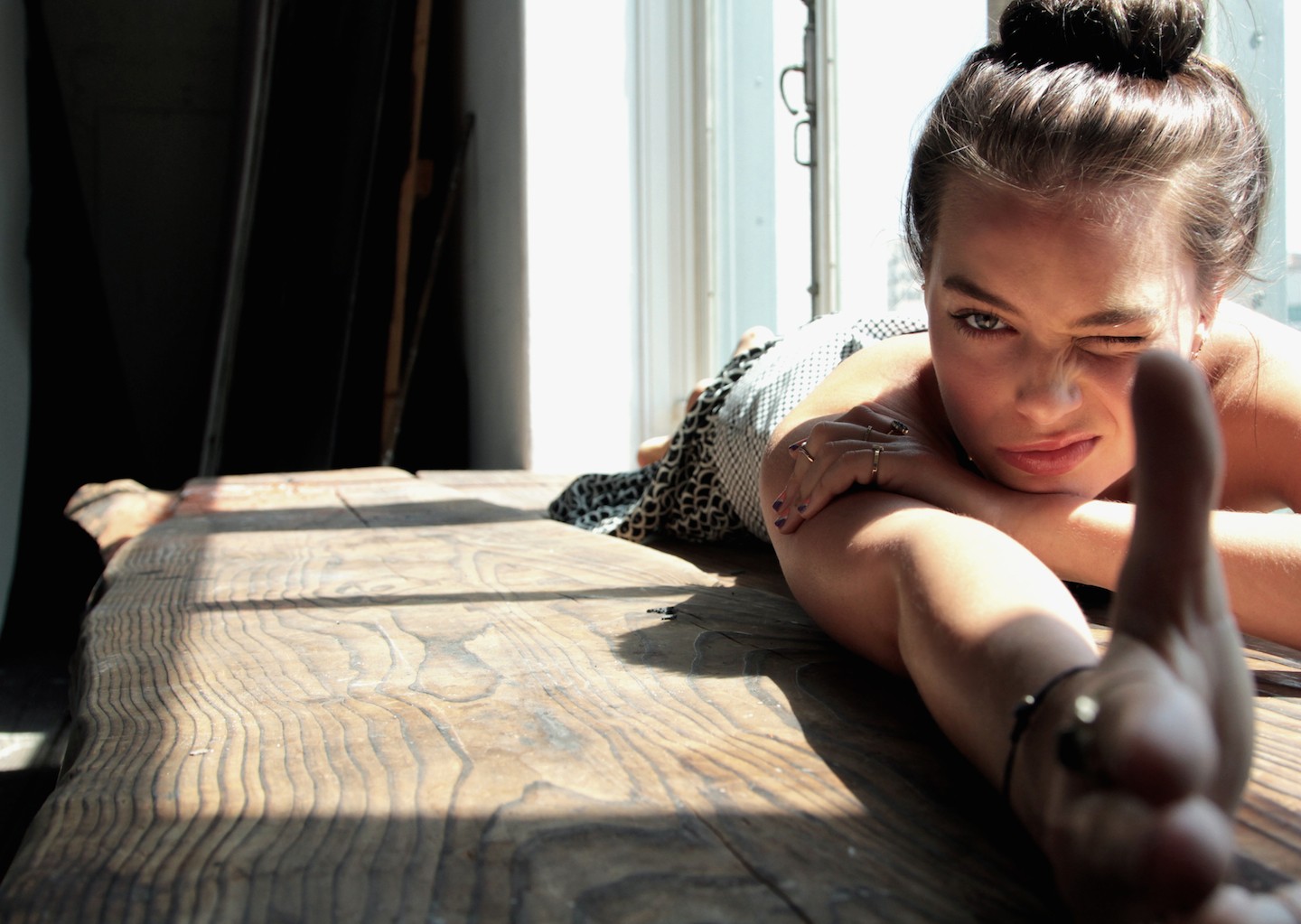 Margot Robbie lying on a wooden table HD Wallpaper