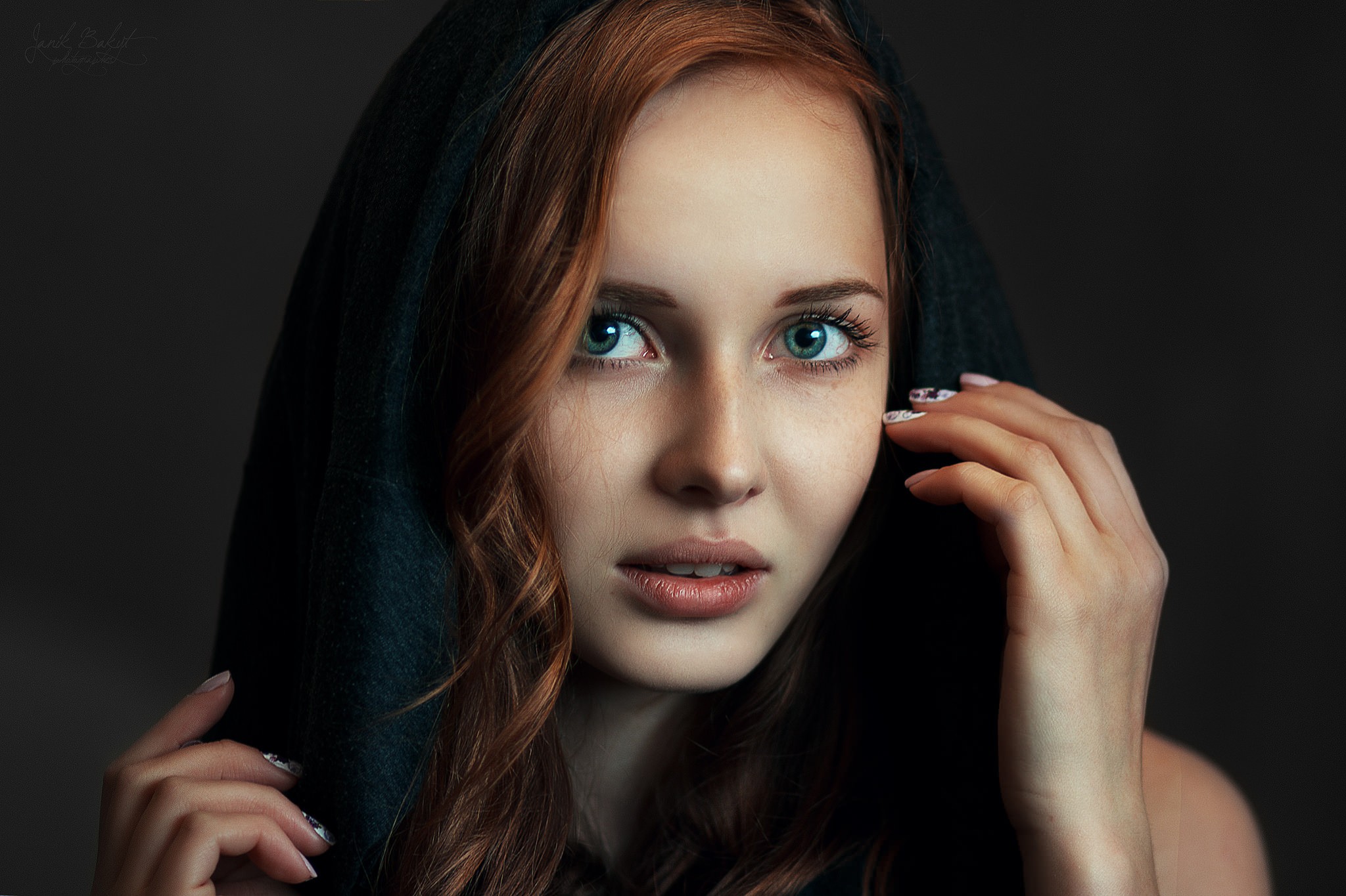 Portrait of a redhead woman wearing a dark hood HD Wallpaper
