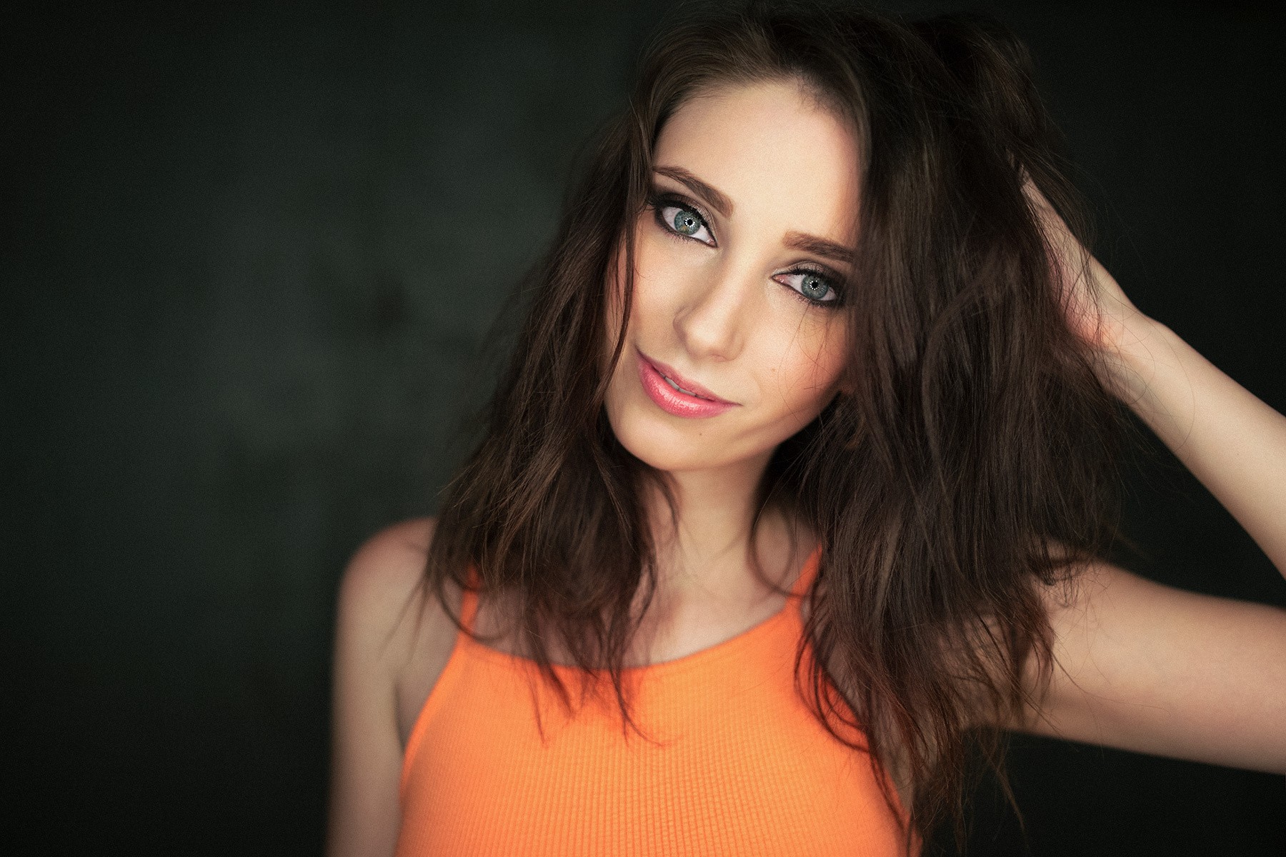 Woman with hands in hair, portrait HD Wallpaper