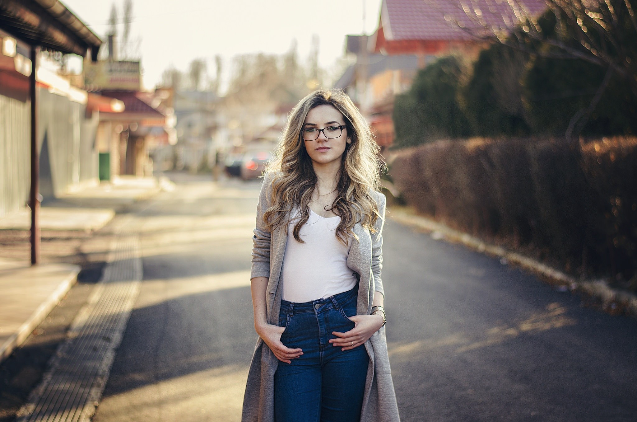 Woman with glasses standing on a street HD Wallpaper