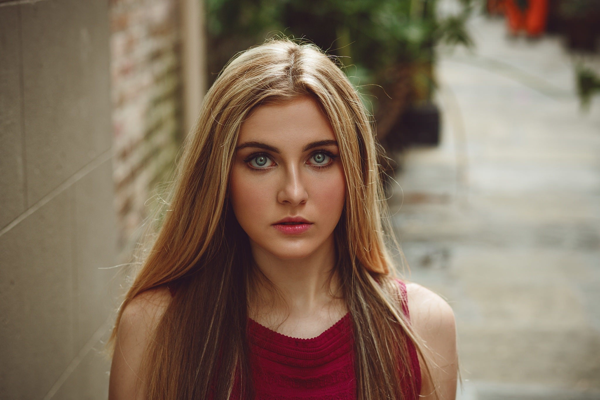 Blonde woman with blue eyes in a red top HD Wallpaper