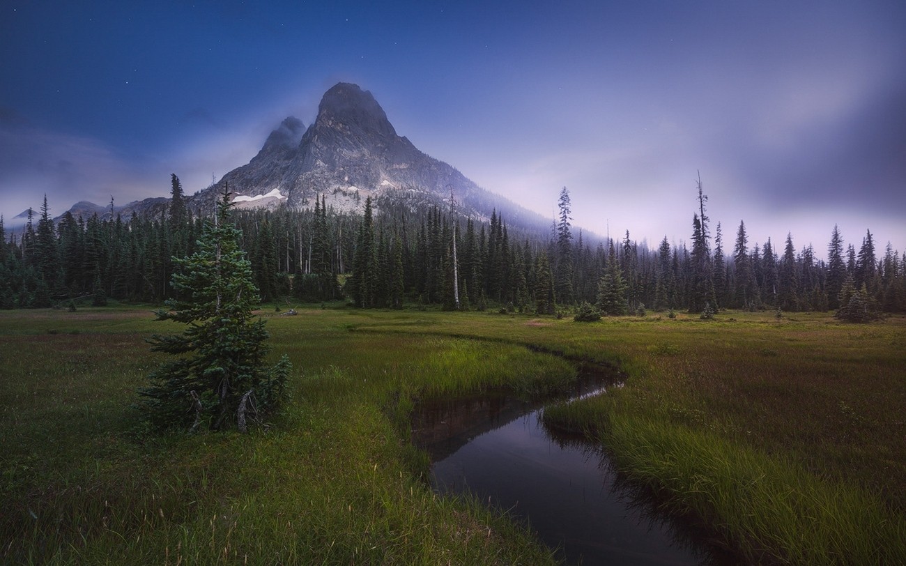Misty mountains and forest with a winding river at dusk HD Wallpaper