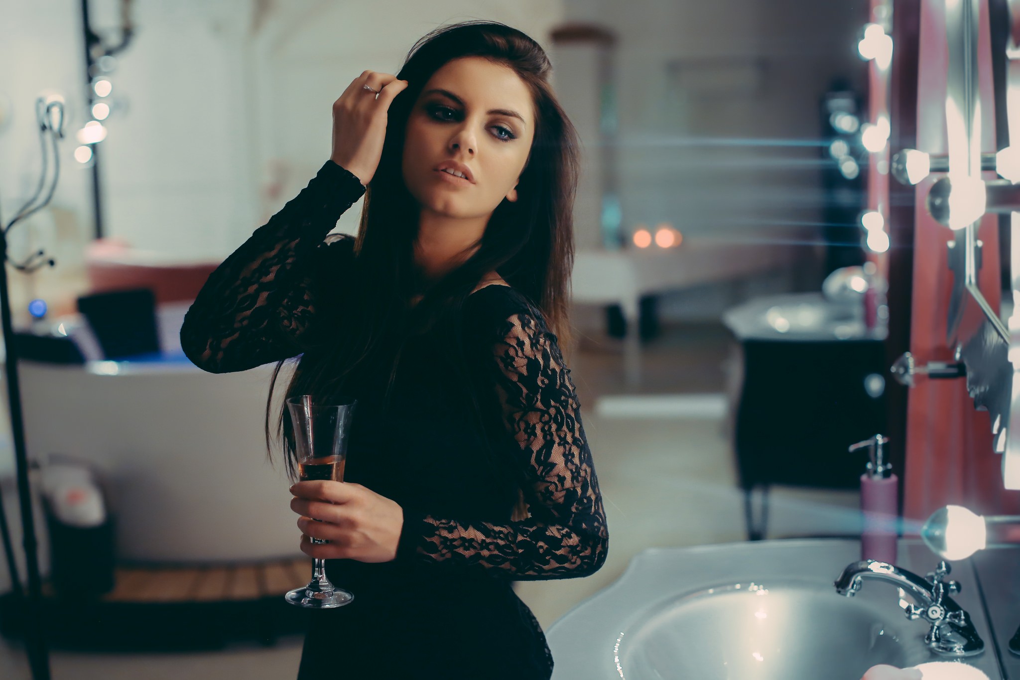 Aurela Skandaj in a black lace dress holding champagne HD Wallpaper