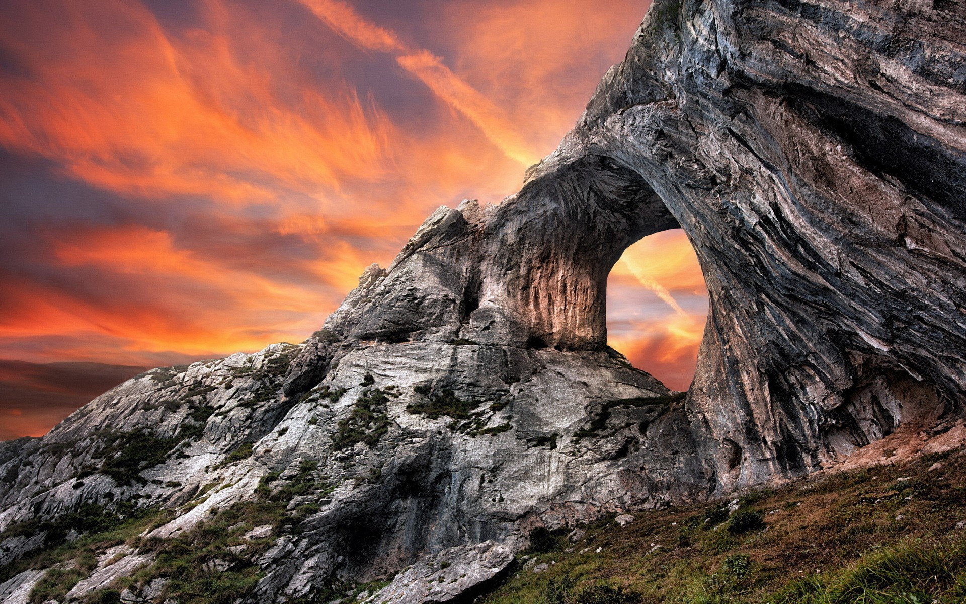 Rock formation with arch against a sunset sky HD Wallpaper