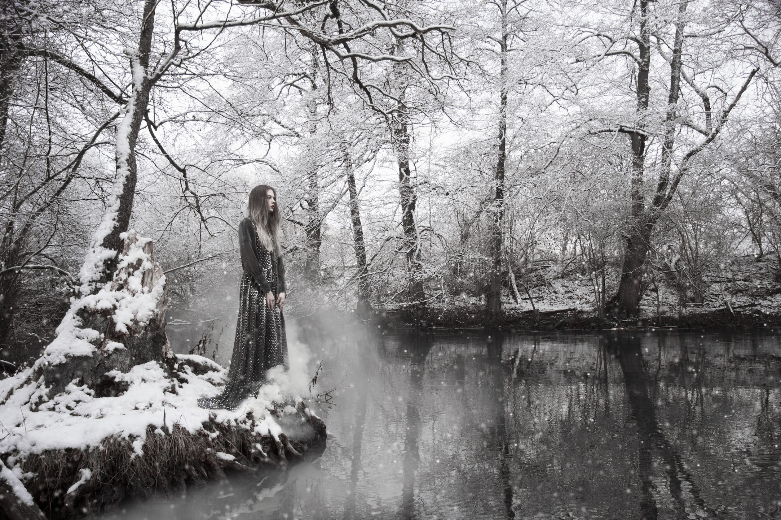 Woman in a dress in a snowy forest by a river HD Wallpaper