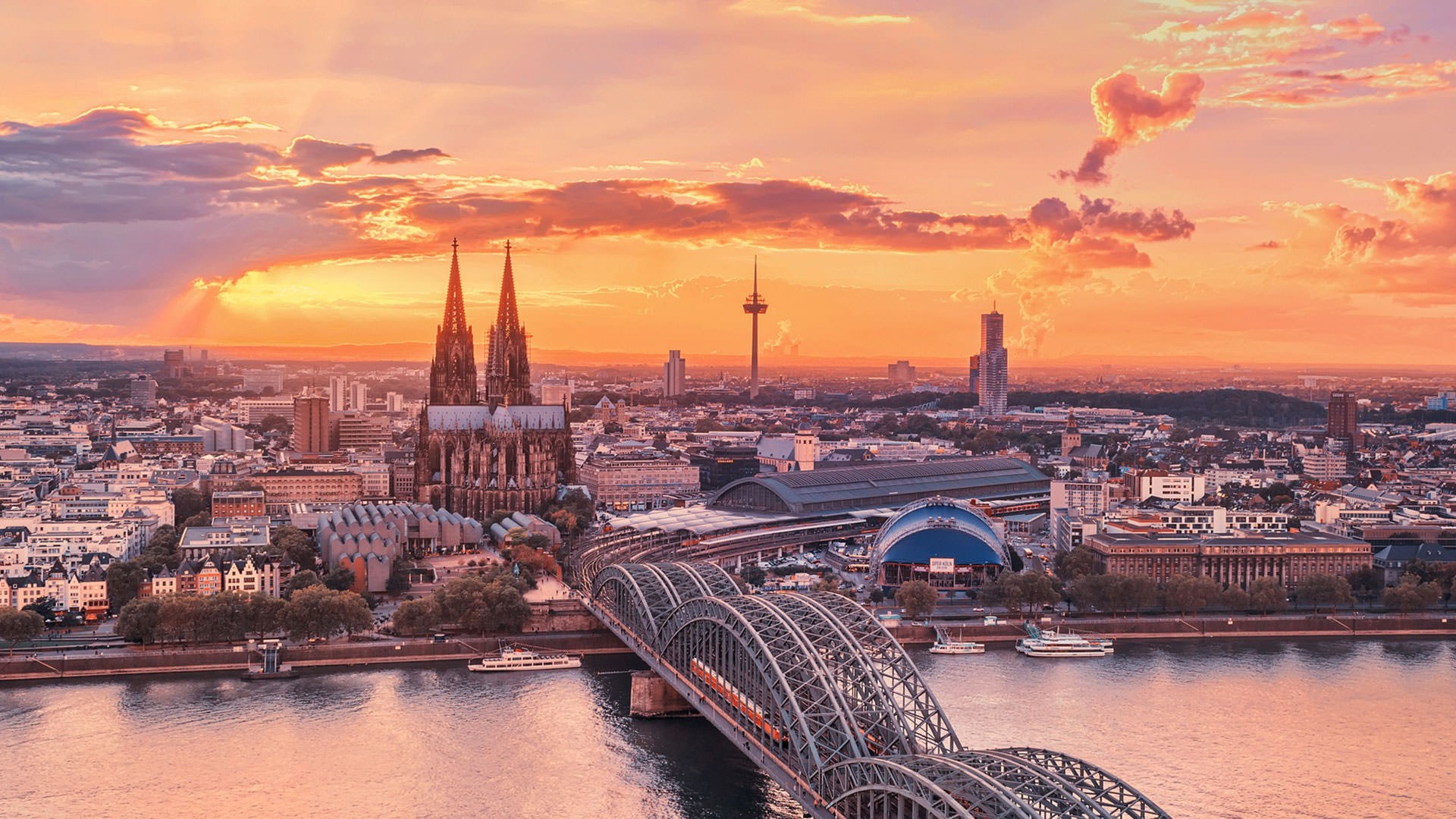 Cologne Cathedral and Hohenzollern Bridge at sunset HD Wallpaper
