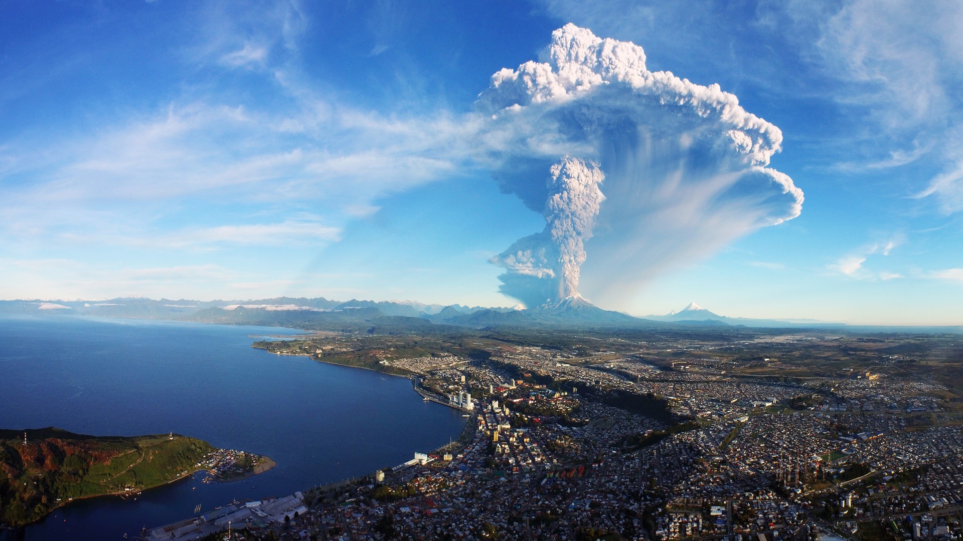 sea city aerial view mountains eruption house water nature building snowy peak coast volcano clouds hills cityscape birds eye view Chile smoke HD Wallpaper