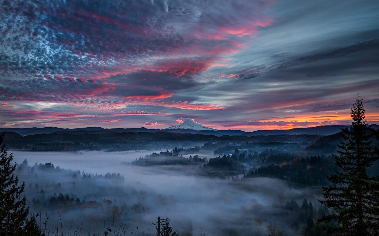 Misty valley and snowy peak at sunrise with colorful clouds HD Wallpaper