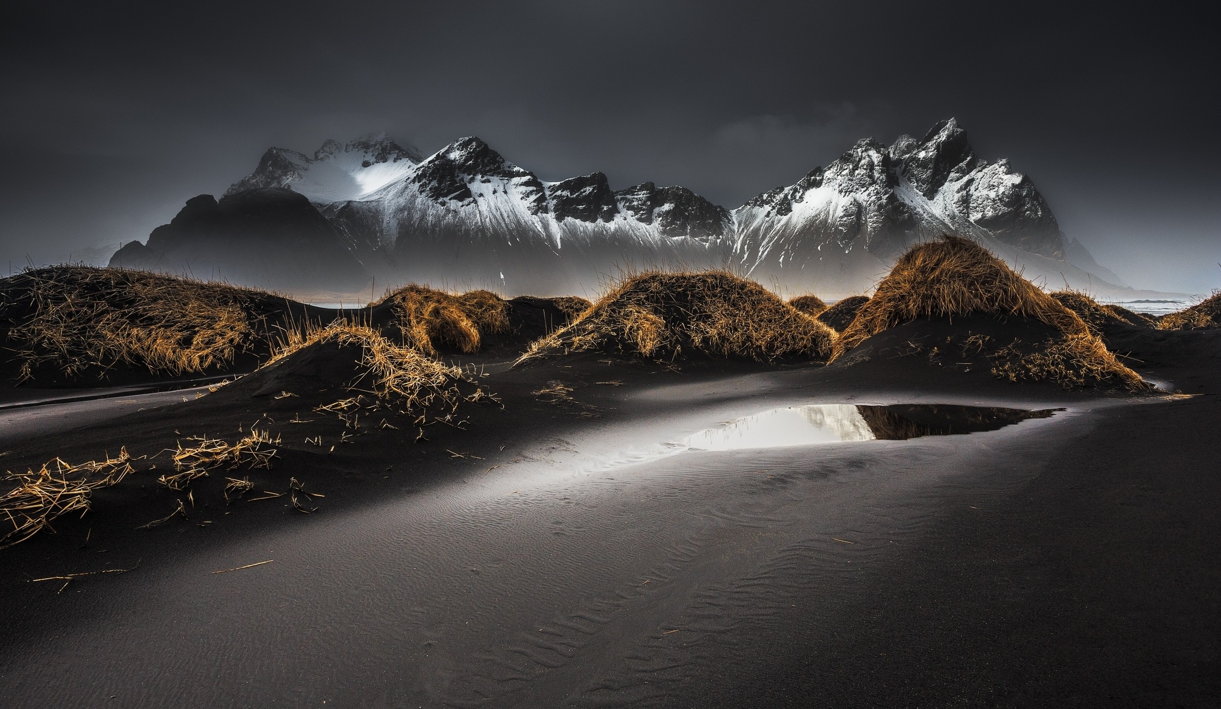 Black sand dunes and snowy mountains in Iceland HD Wallpaper