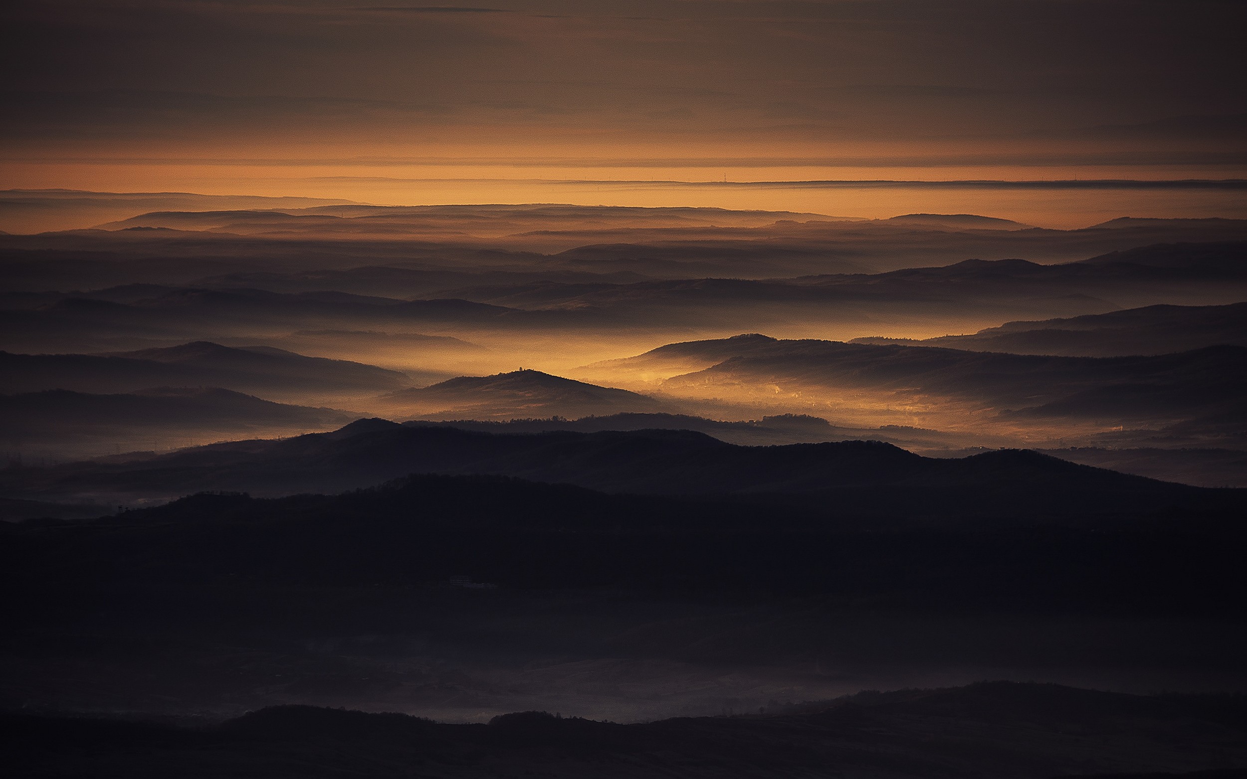 Golden mist over layered mountains in Romania HD Wallpaper