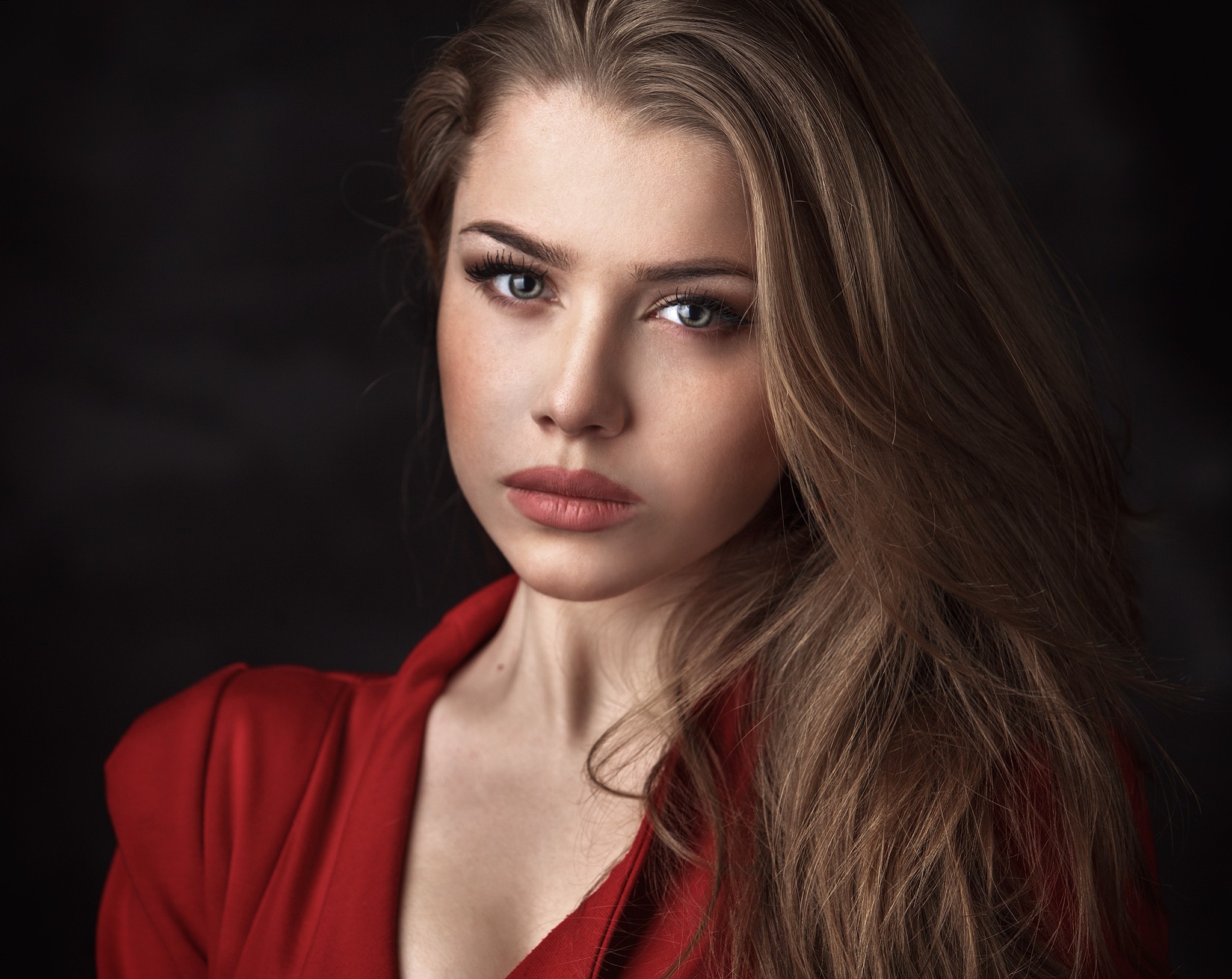 Portrait of a blonde woman in a red jacket HD Wallpaper