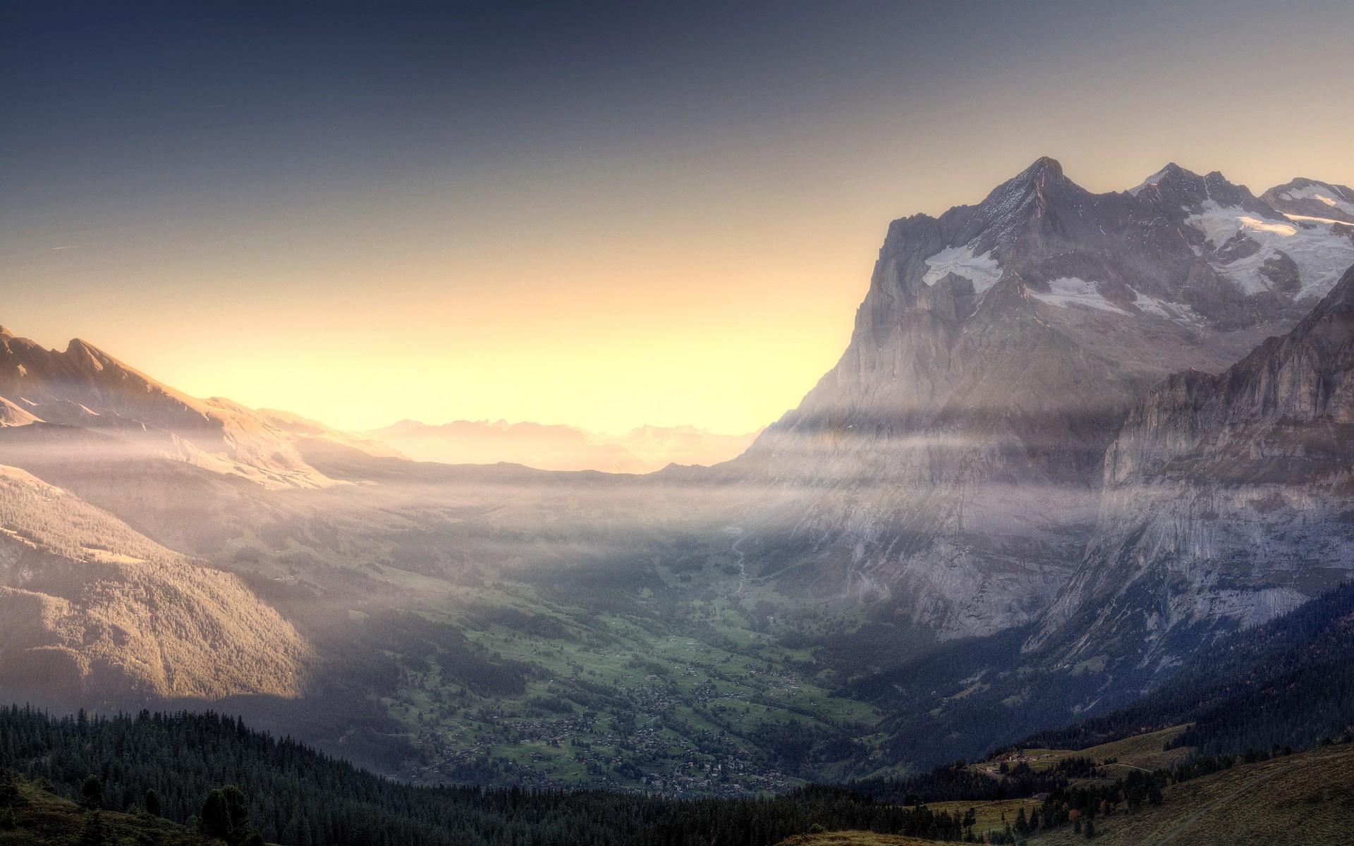 Misty valley with mountains at sunrise HD Wallpaper