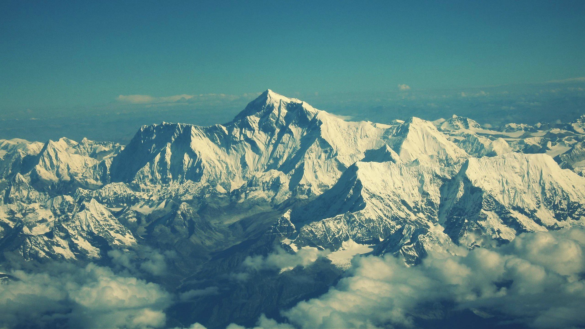 Snow-capped mountains under a clear blue sky HD Wallpaper