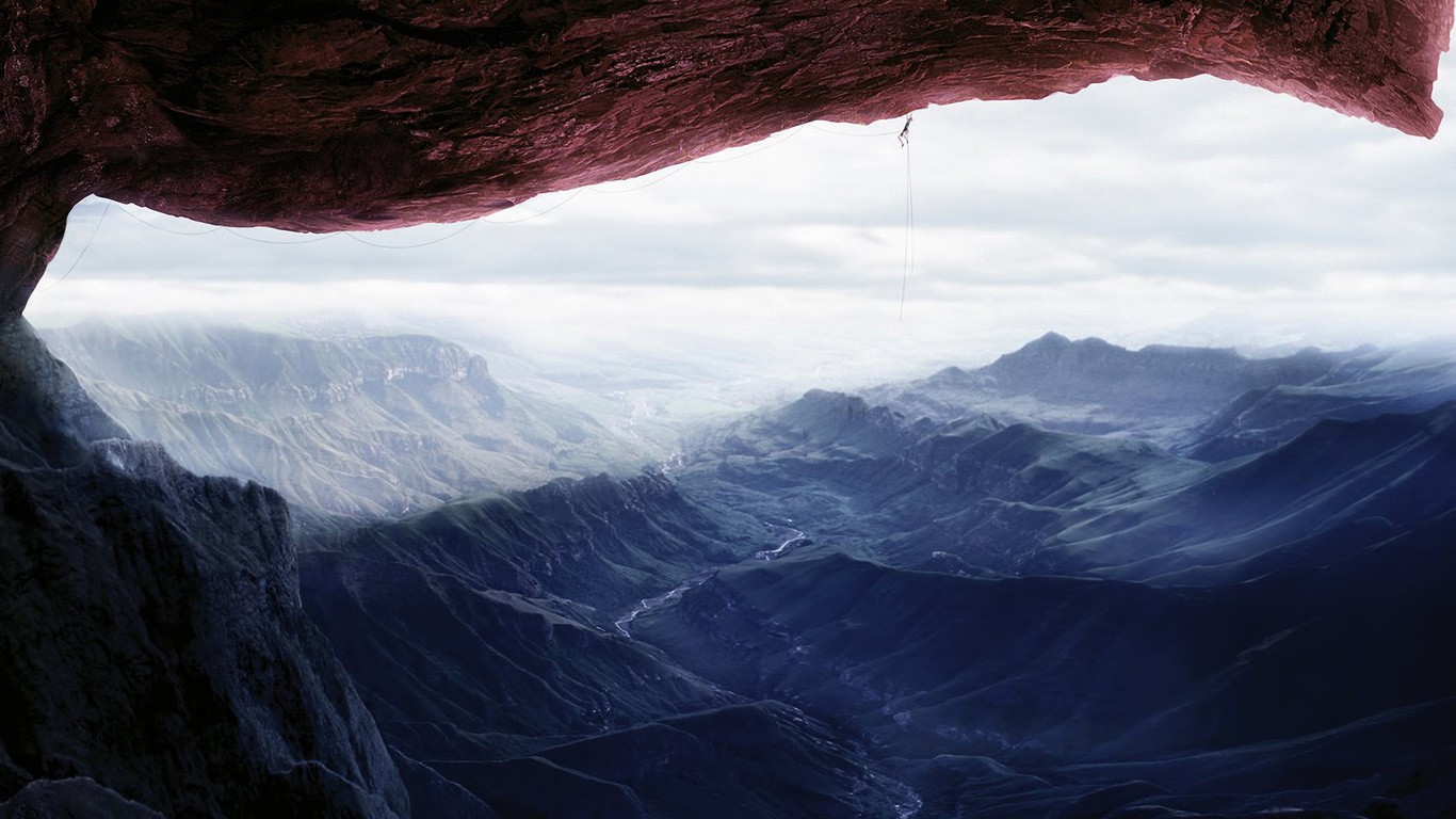 Bungee jumper suspended over a vast mountain valley HD Wallpaper