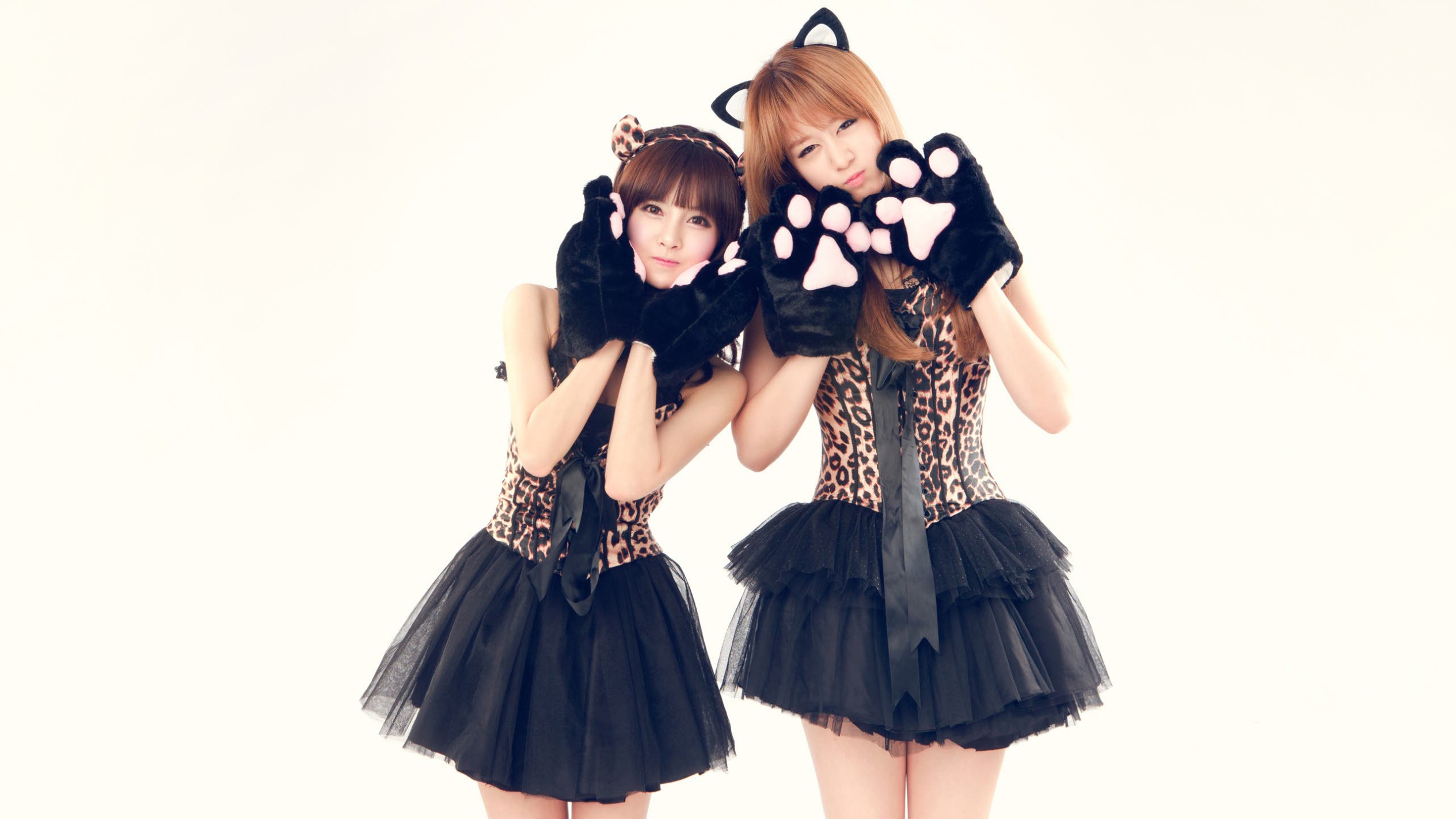 Two women in leopard print dresses with cat ears and paws HD Wallpaper
