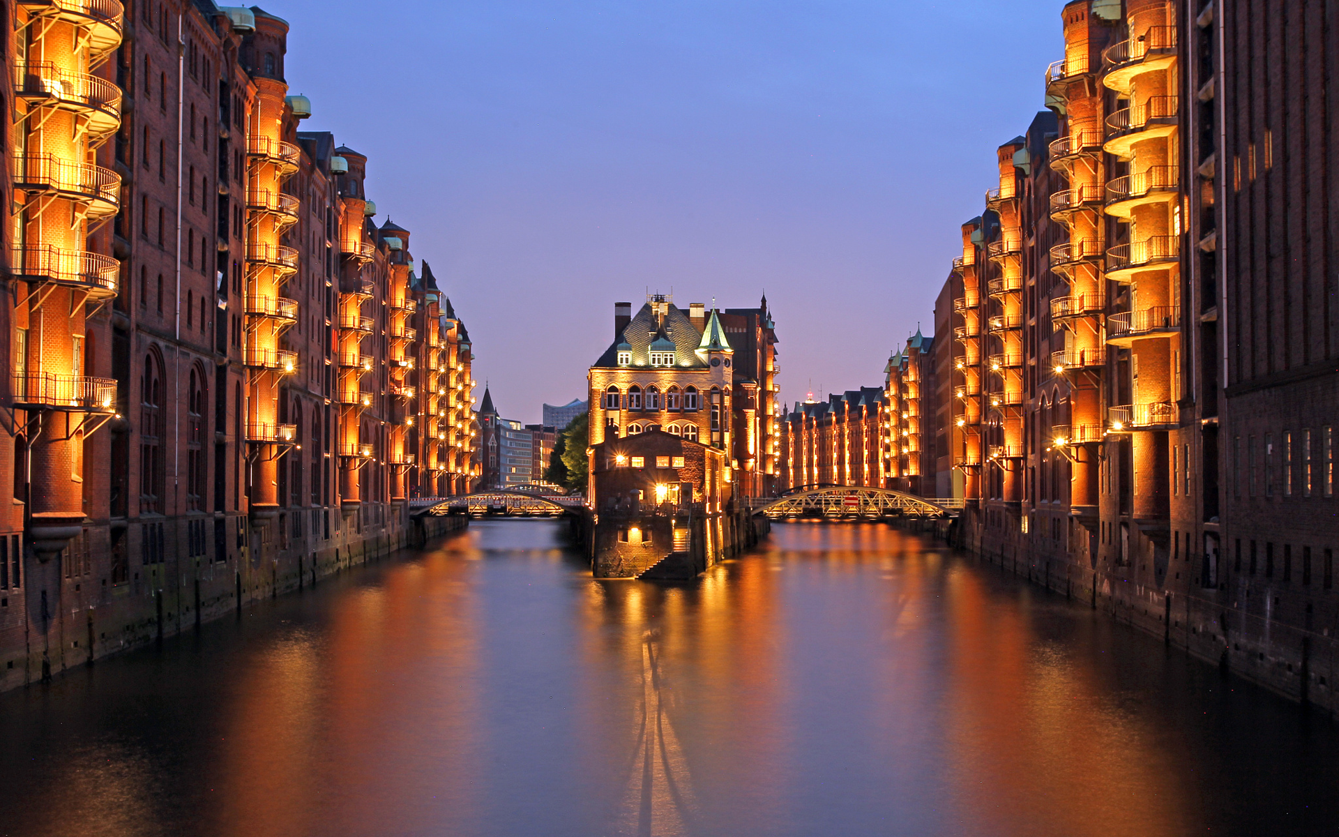 Speicherstadt Hamburg at dusk with illuminated buildings and canals HD Wallpaper