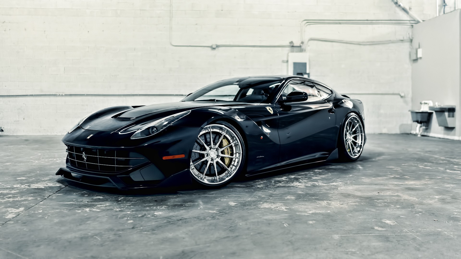 Black Ferrari F12 parked in a garage HD Wallpaper