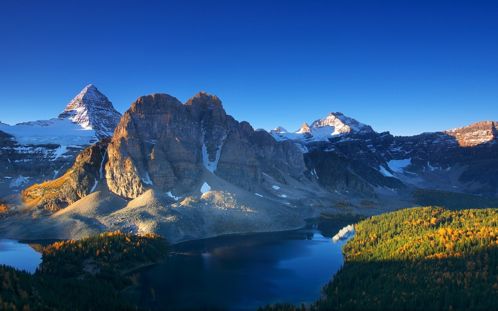 Snowy mountain peaks over a lake and autumn forest HD Wallpaper