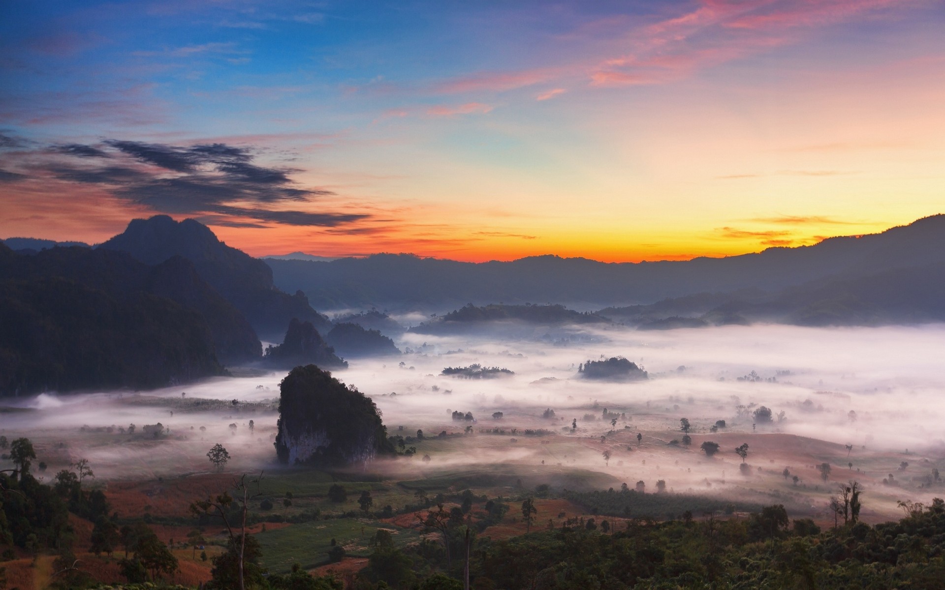Misty mountain valley at sunrise with colorful clouds HD Wallpaper