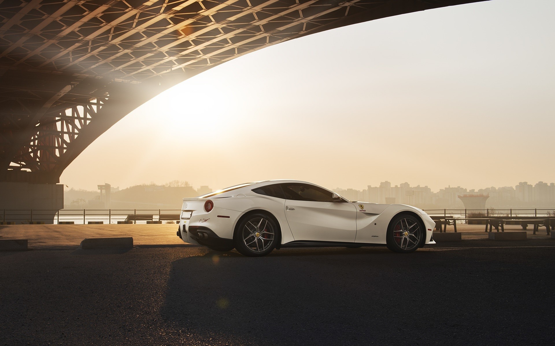 White Ferrari parked under a bridge at sunset HD Wallpaper