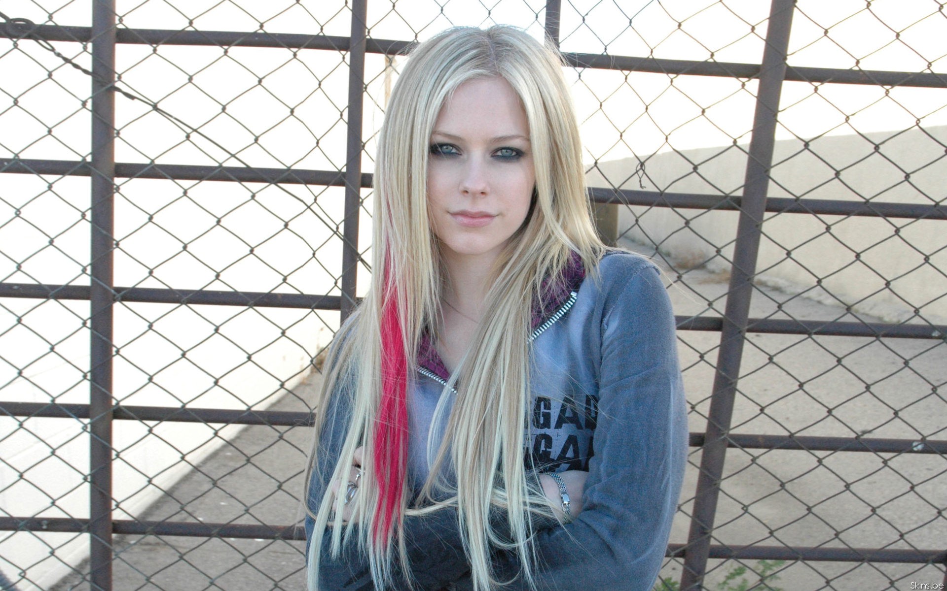Avril Lavigne standing in front of a fence HD Wallpaper