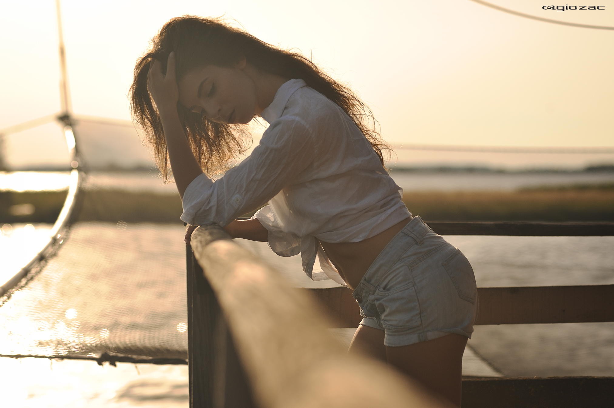 Woman in jean shorts with hands in hair HD Wallpaper