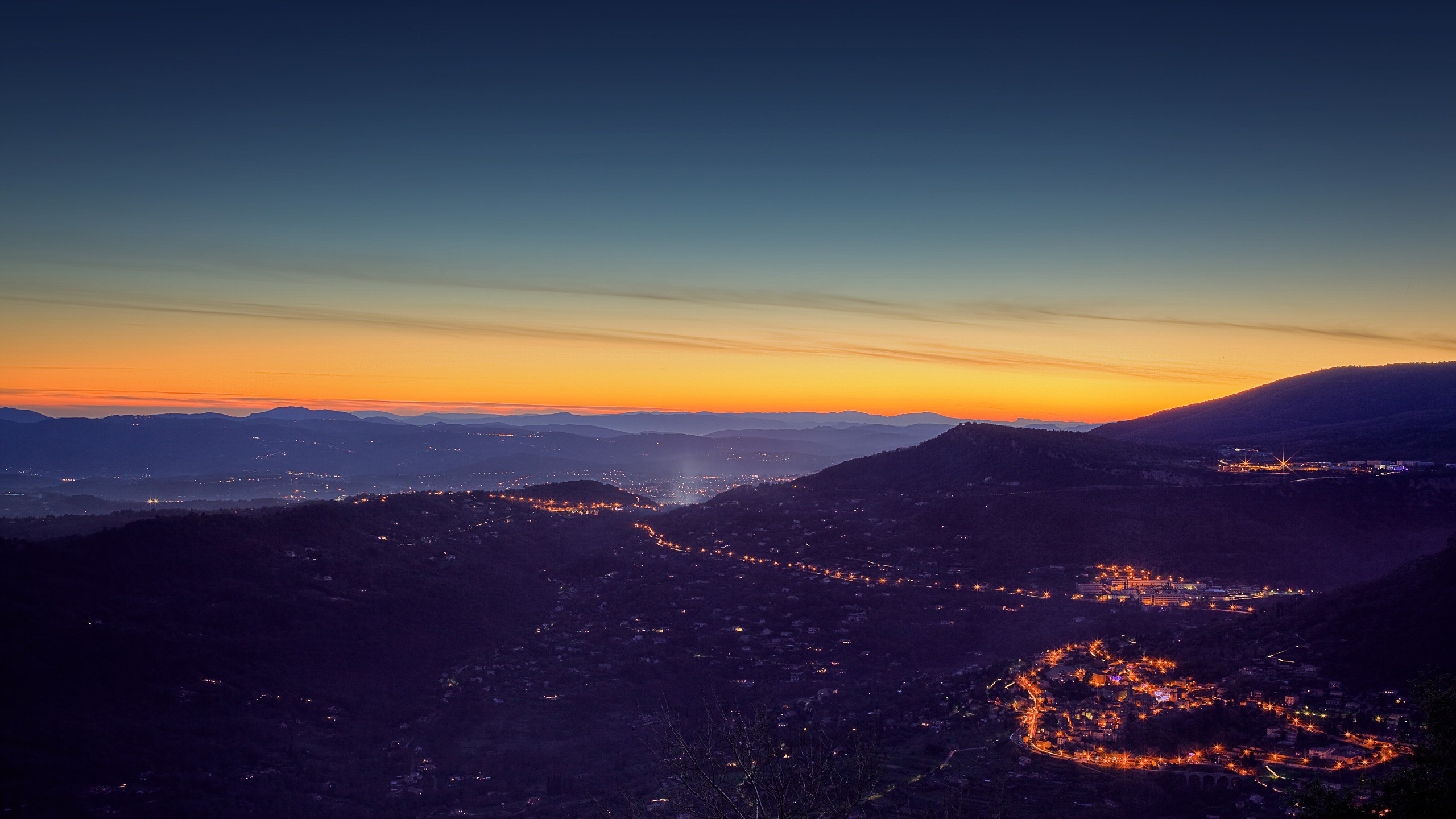 Cityscape at dusk with glowing lights HD Wallpaper
