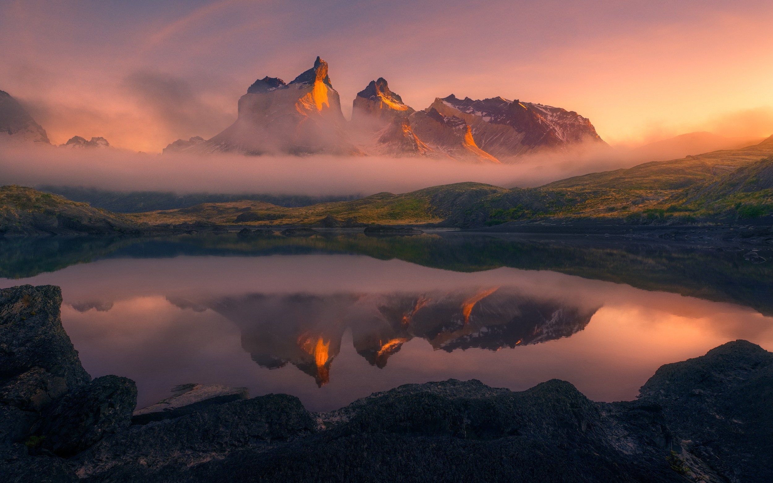 Torres del Paine mountains reflected in a lake at sunrise HD Wallpaper
