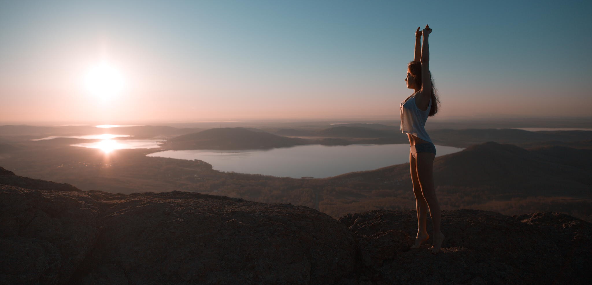 Woman stretching on a mountain at sunrise HD Wallpaper