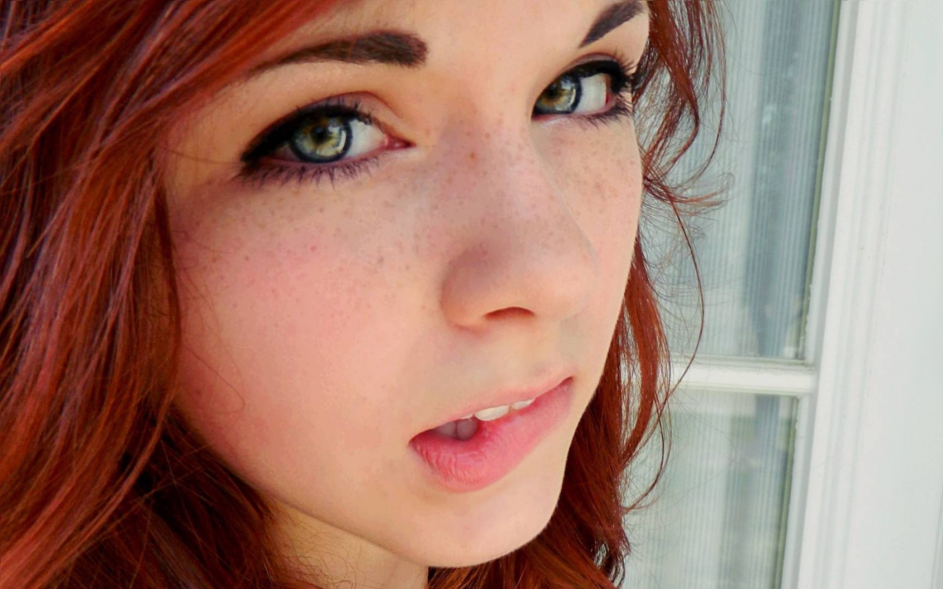 Close-up of a young woman with red hair and freckles HD Wallpaper