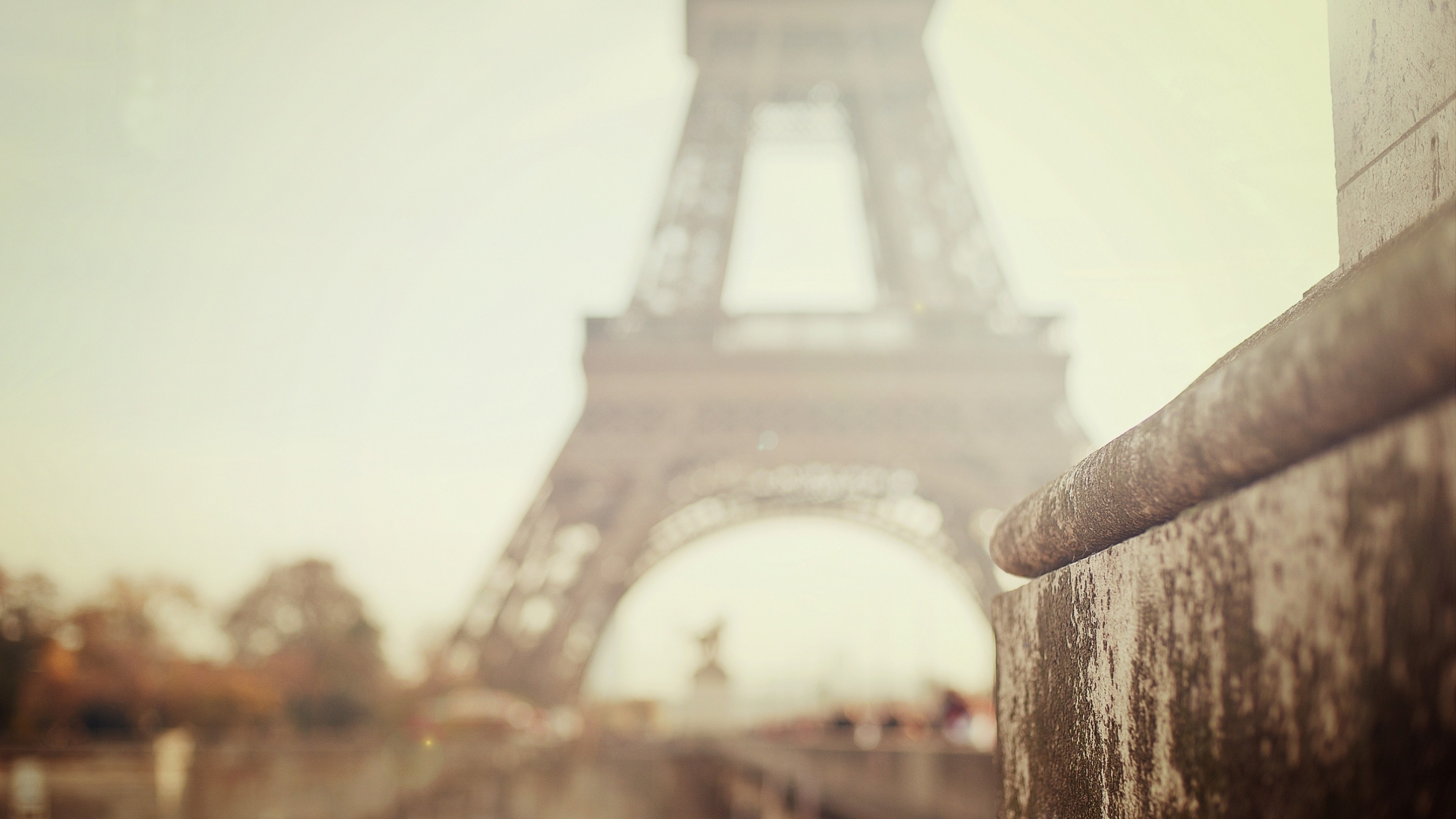 Eiffel Tower in Paris with a stone railing in the foreground HD Wallpaper