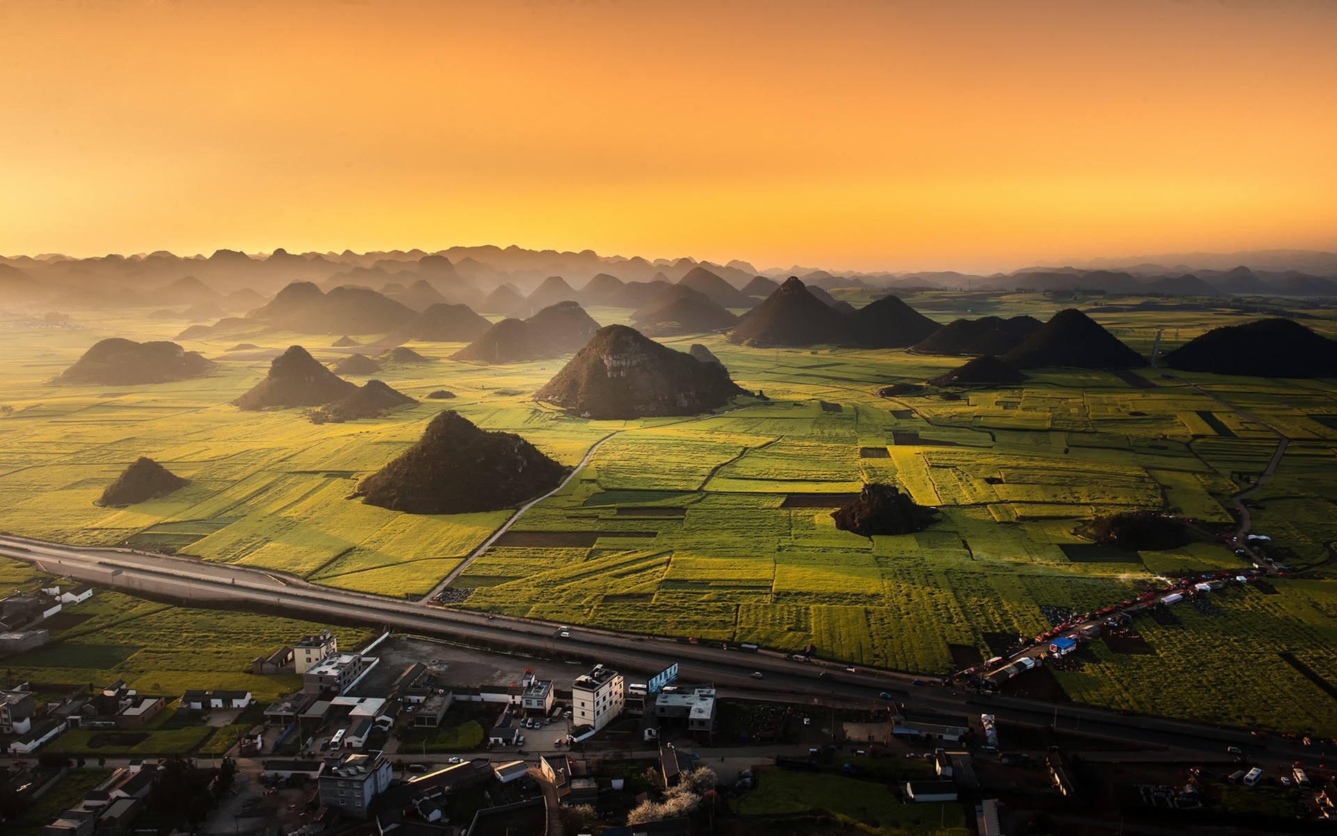 Aerial view of karst landscape and rapeseed fields in China HD Wallpaper