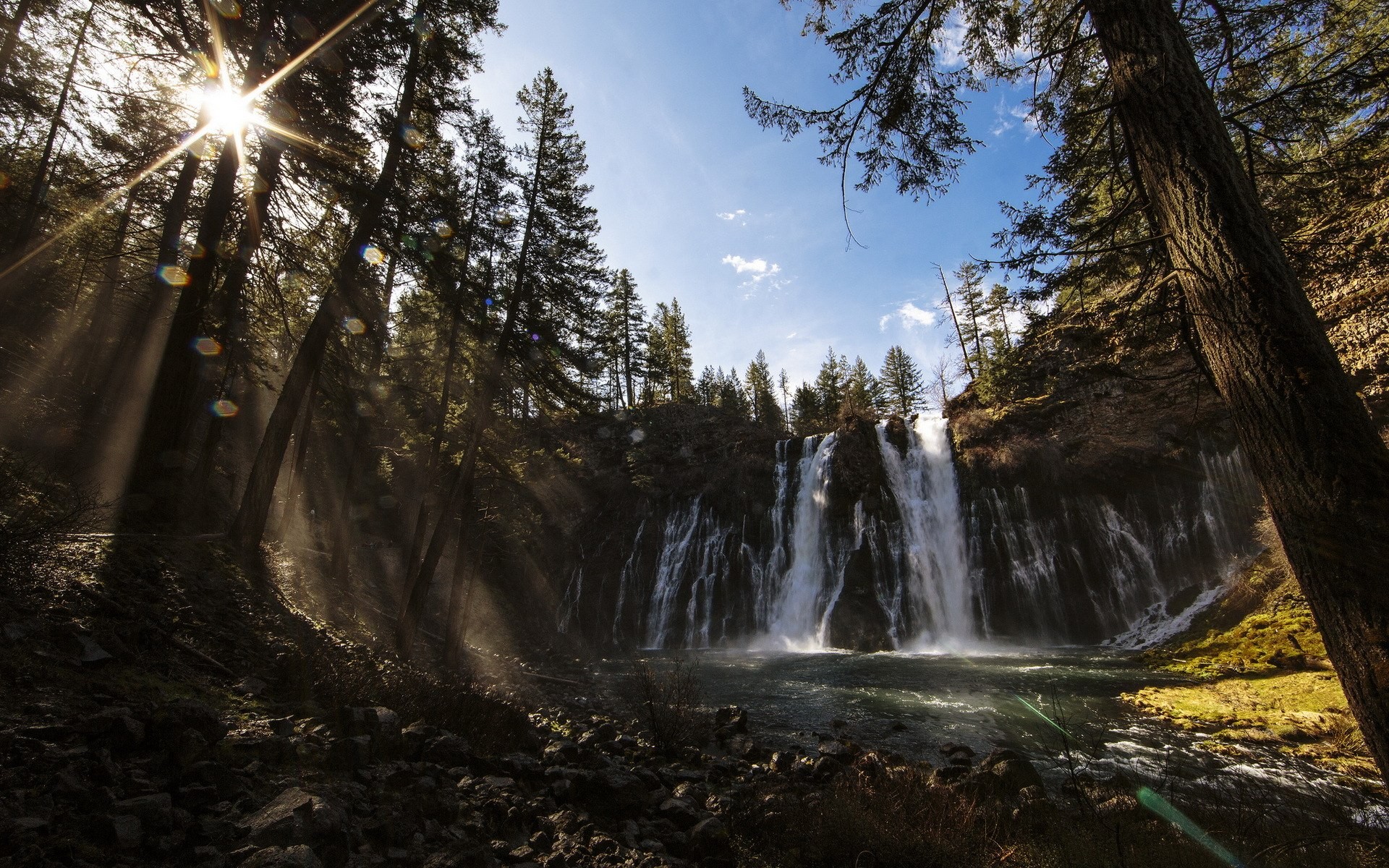 Waterfall in a forest with sunbeams HD Wallpaper
