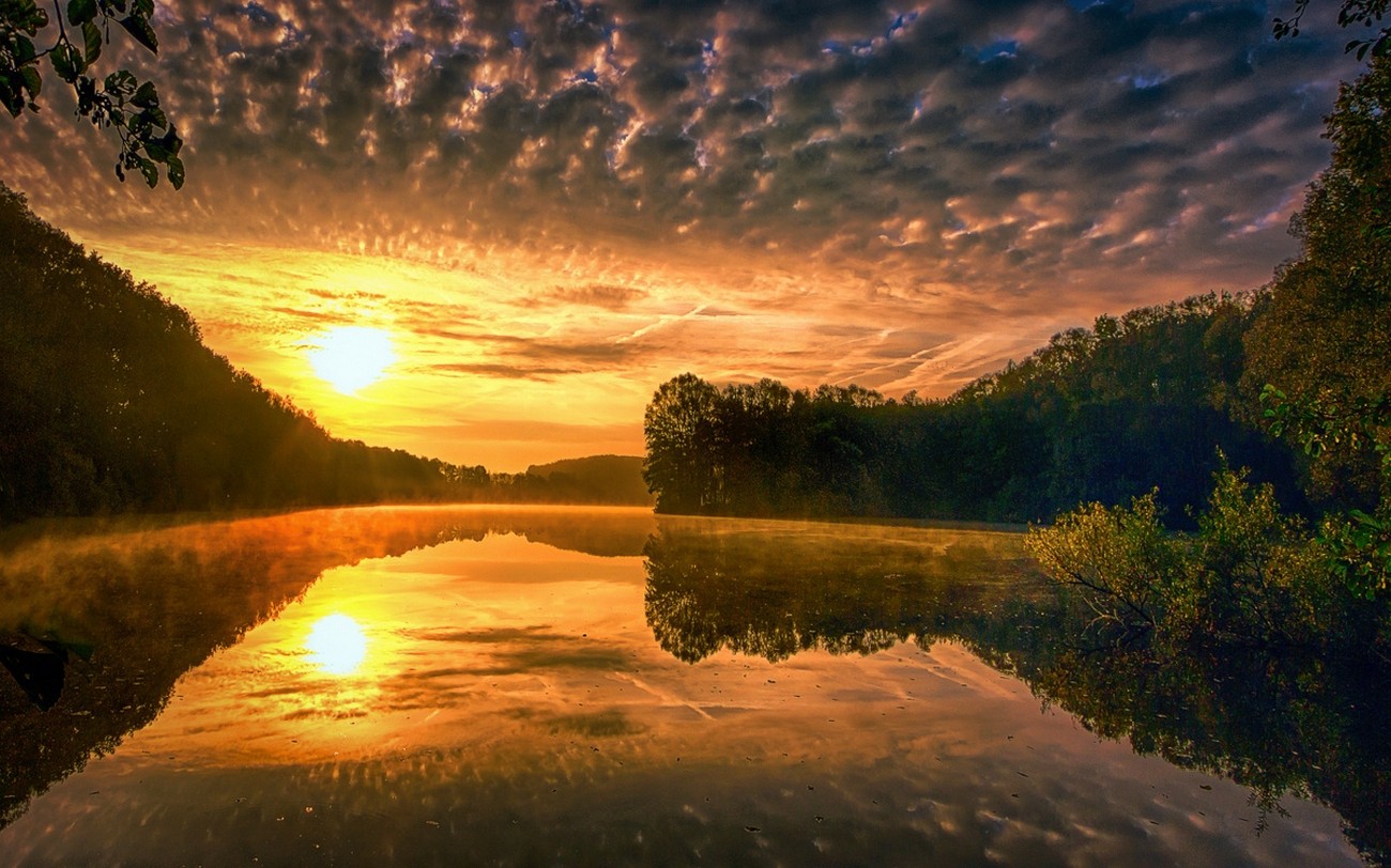 Sunrise over a misty lake with forested hills HD Wallpaper