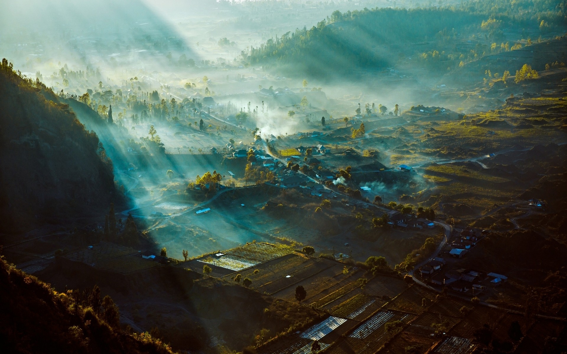 Sun rays over a misty valley in Indonesia HD Wallpaper