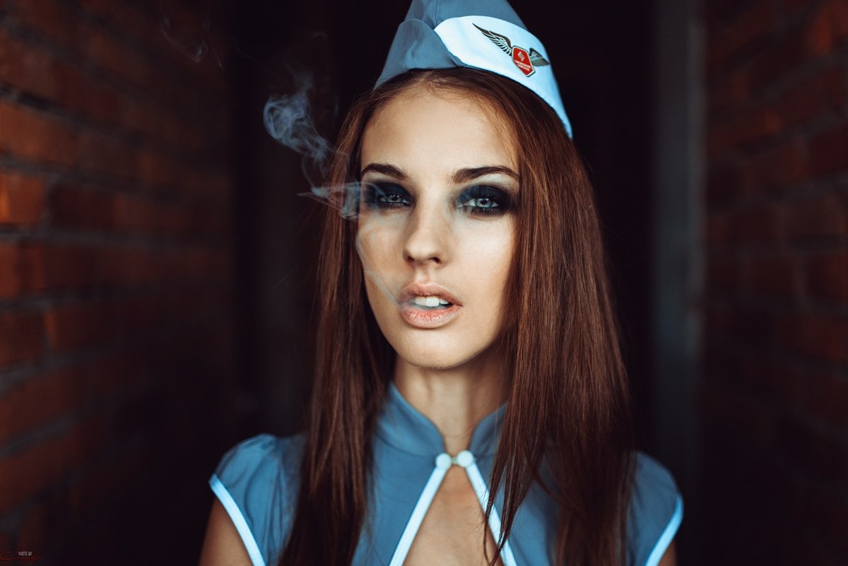Alla Berger smoking in front of a brick wall HD Wallpaper