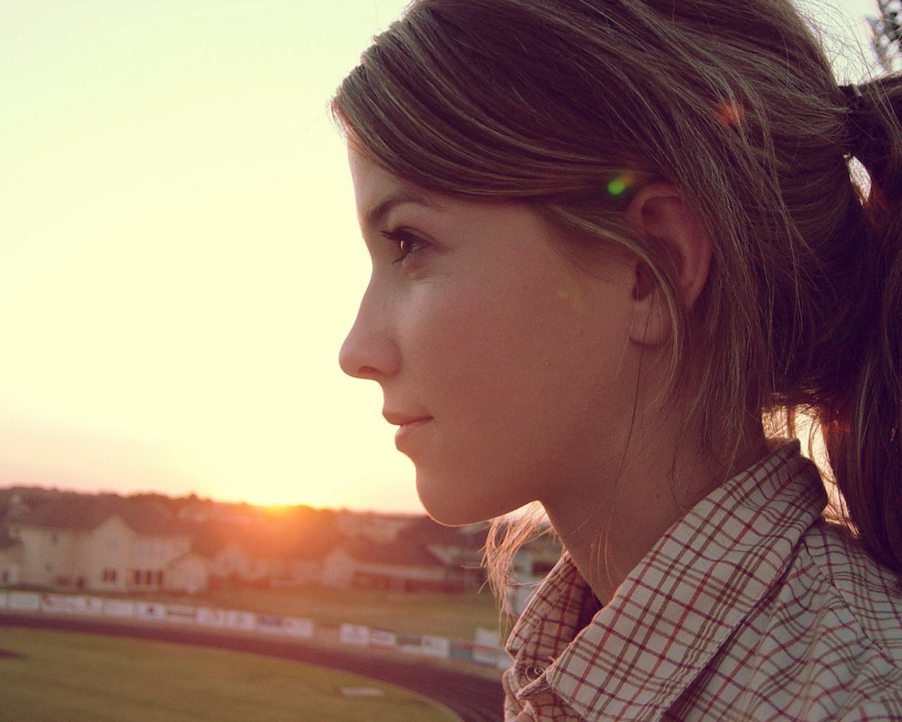 Woman in plaid shirt looking at sunset HD Wallpaper